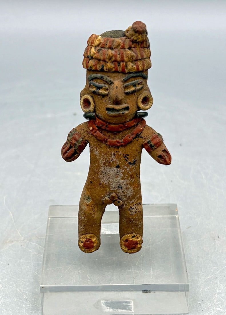Tlatilco figurine from Mexico: A superb Tlatilco figurine from Mexico, ca. 1200-500 BC. This standing male is 3-1/4 in. tall and is lavishly adorned with a fancy headdress, large earspools, necklaces, bracelets and what likely