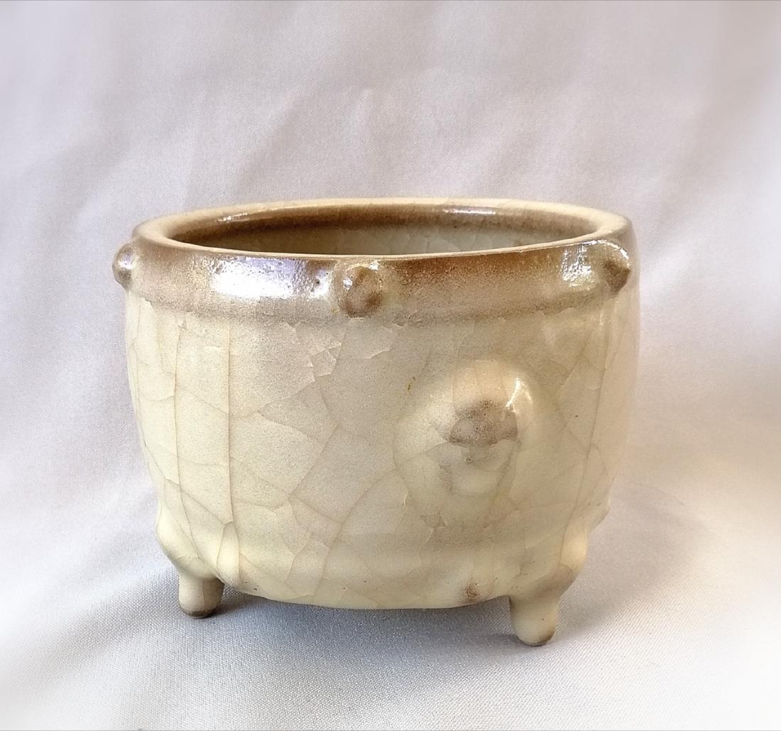 CHINESE SONG DYNASTY GUAN GLAZE INCENSE: Chinese Song dynasty Guan glaze three footed incense decorated with drum nails Measures: H: 10 cm; D: 13 cm. Circa: Song dynasty or pre-1800. Condition: Typical wear commensurate to age. Domestic ship