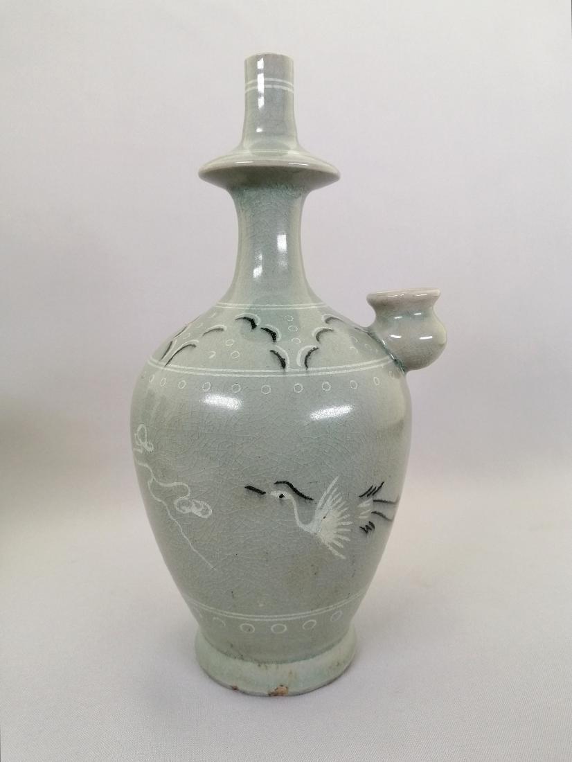 An elegant Korea hand washing pitcher: An elegant Korea hand washing pitcher decorated with flying crane chasing clouds. MEASUREMENT: H: 25.7 cm; D: 13.5 cm. CIRCA: Likely Joseon dynasty or Pre- 1800. CONDITION: Good antique condition with