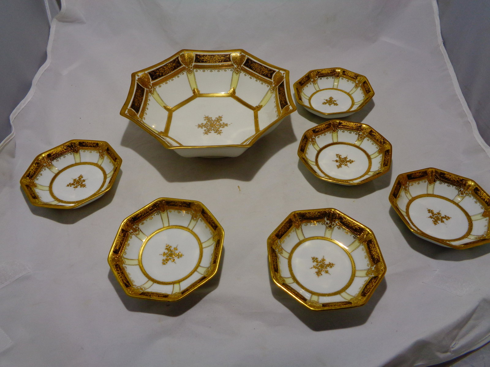 Nippon dish set 6 small 1 large (7 in set): hand painted RC Nippon dish set gold encrusted salad bowl with 6 smaller bowls hand painted 9.5 inchx2.75 tall (large) small are 4.75 widex1.25 tall