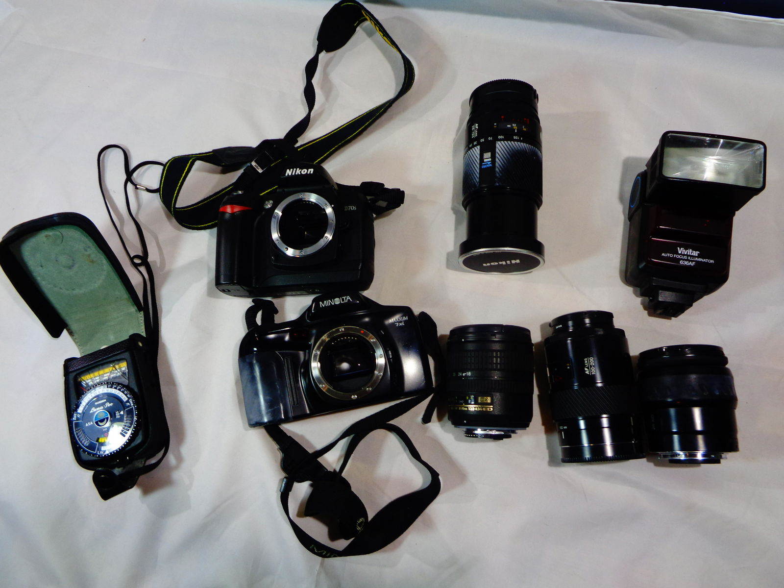 Camera lot 2 film cameras & Accessories (8): Nikon D70S with charger, Minolta Maxxum 7xi, 4 zoom lenses (1 Nikon dx af-s nikkor, Minolta AF lense 100-200, Minolta AF 28-135,Minolta zoom xi AF 28-105, Vivtar flash 636AF, Luna- (cracked display)