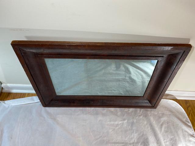Antique hand carved wooden mirror: Antique dark wood hand made hand carved mirror with old glass 30longx21