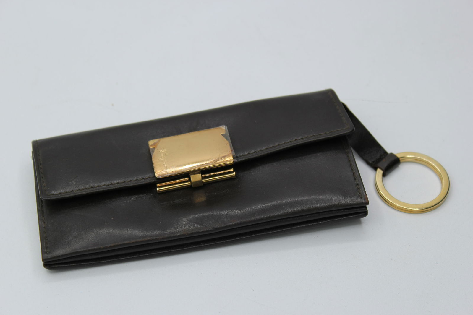Ferragamo Leather Wallet: Ferragamo brown leather wallet with gold hardwear and cinch close