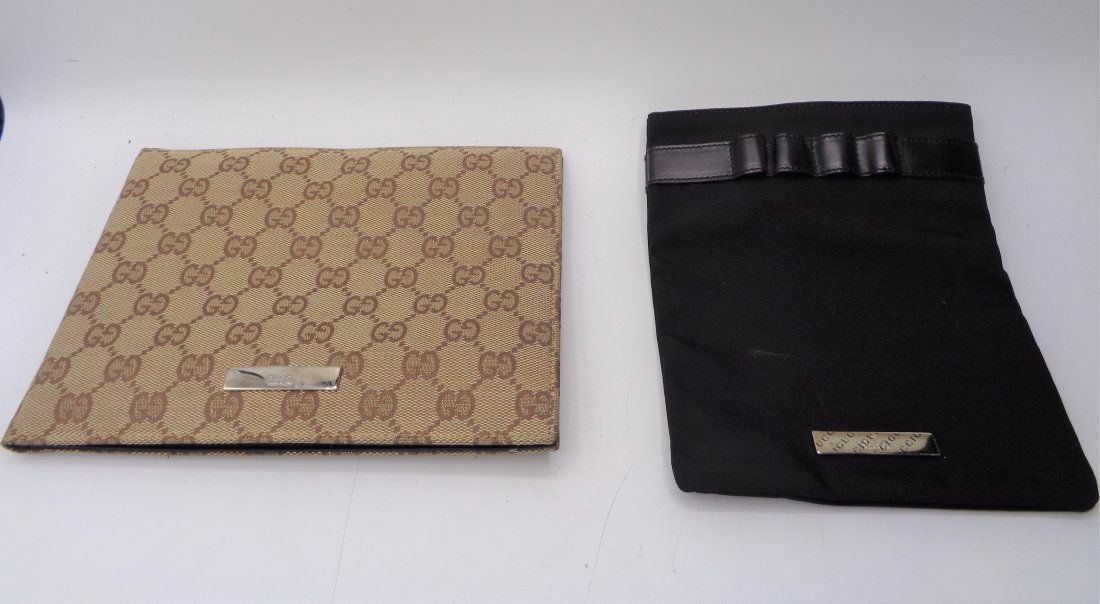 2 Gucci Wallets: 1 Gucci ID/Passport holder 8.5" X 6.25" and 1 Gucci clip-on coin/iphone purse with pen holders.