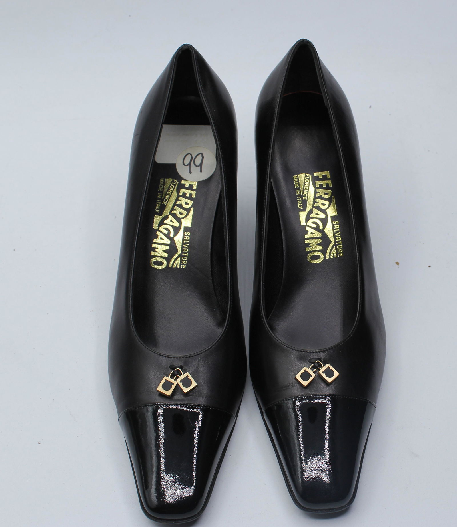Salvatore Ferragamo Women's Pumps: Black closed toe w/ gold accents, size 9B.