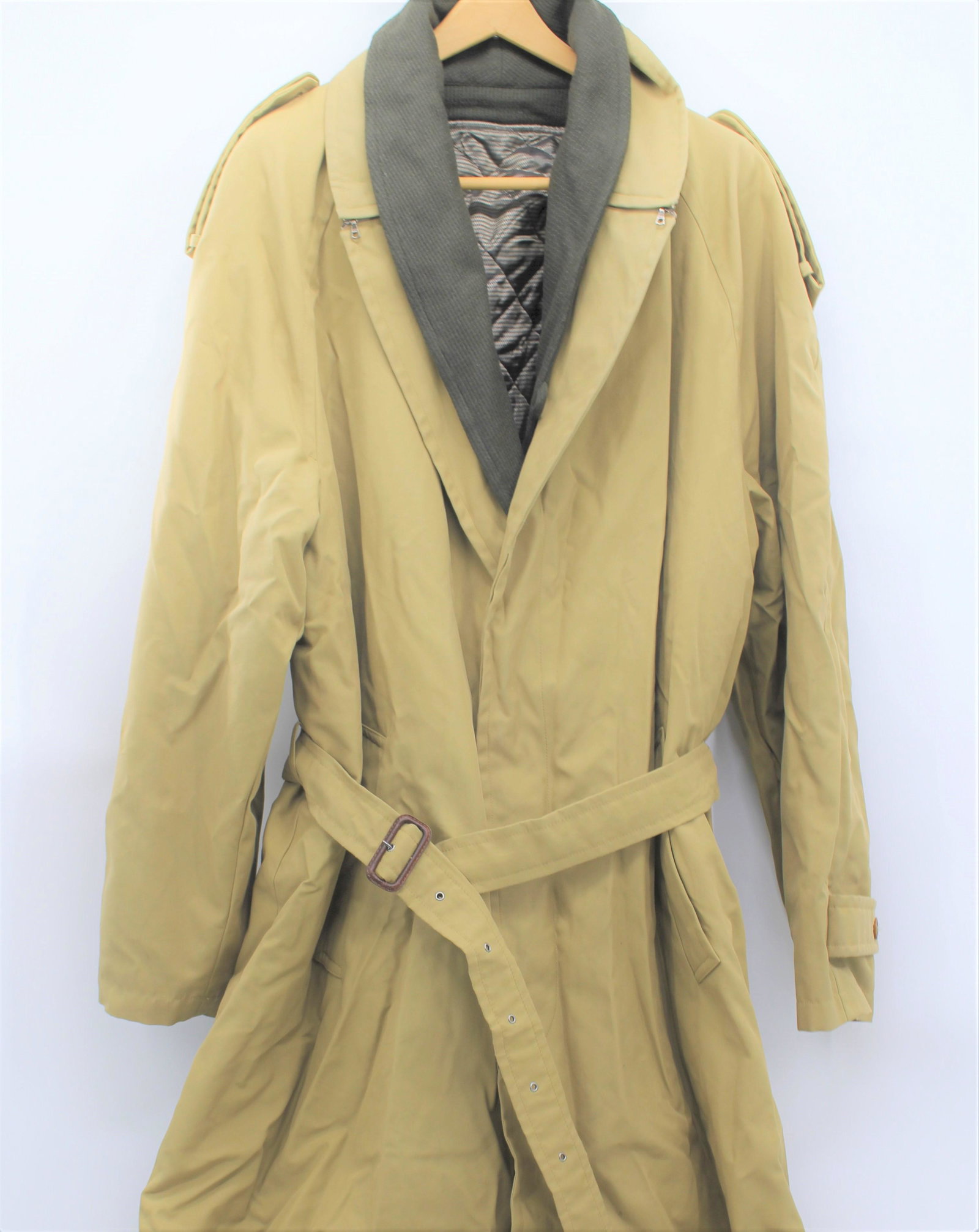 Ermenegildo Zegna Tan Trench Coat: Tan exterior with olive liner. Made in Italy. Removable lining and adjustable belt and wrist feature. Two exterior pockets. and interior button pocket,