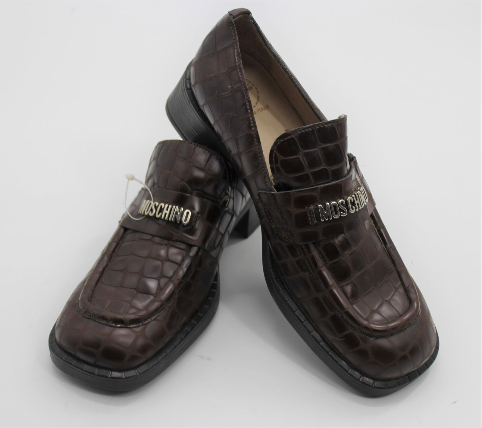 Moschino Women's Loafers: Brown "aligator patterned" leather loafers, with silver Moschino band. Size 37.