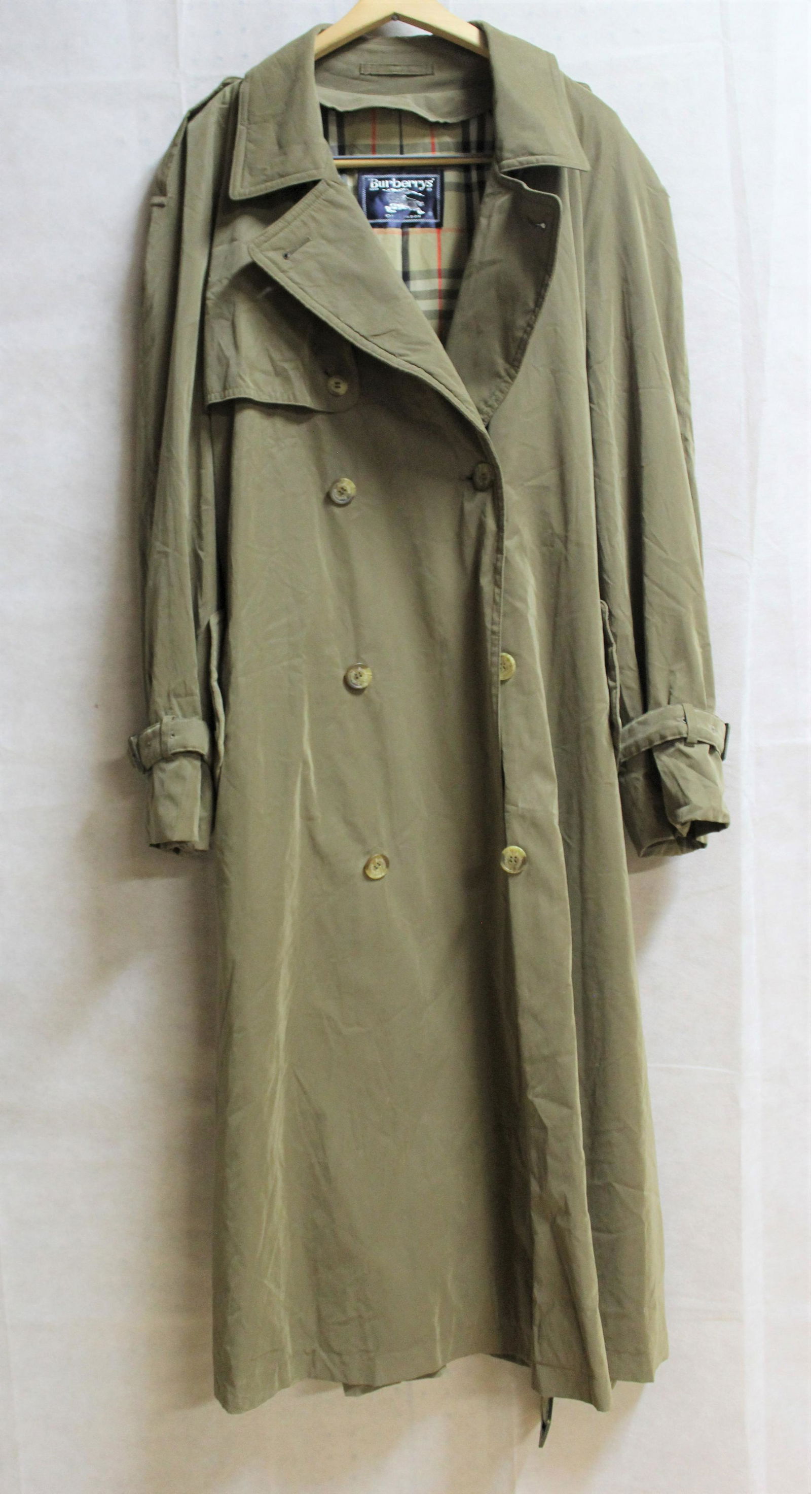 Burberry's of London Trench Coat: Men's Size XL. Beige with belt and 2 interior pockets.