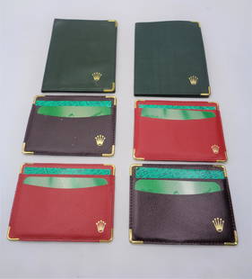 Lot of Rolex Wallets: 2 red, 2 brown, and 2 green fold wallets. Red & brown wallets 4.75x3.50". Green wallets - 4x5.75."