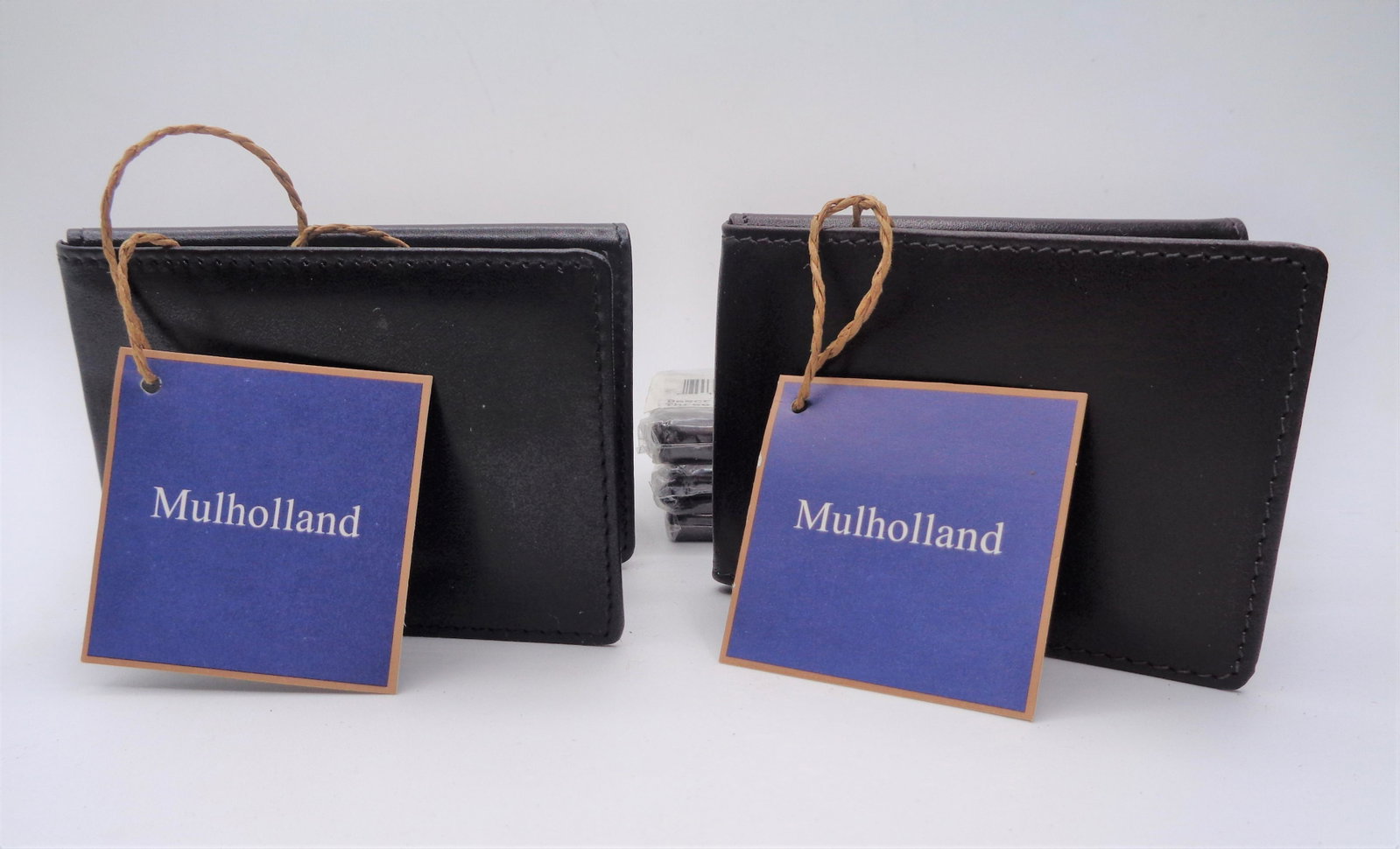Lot of 7 Mulholand Wallets: 7 leather Mulholland three fold wallets. 4 stout, 3 black. 4x3".