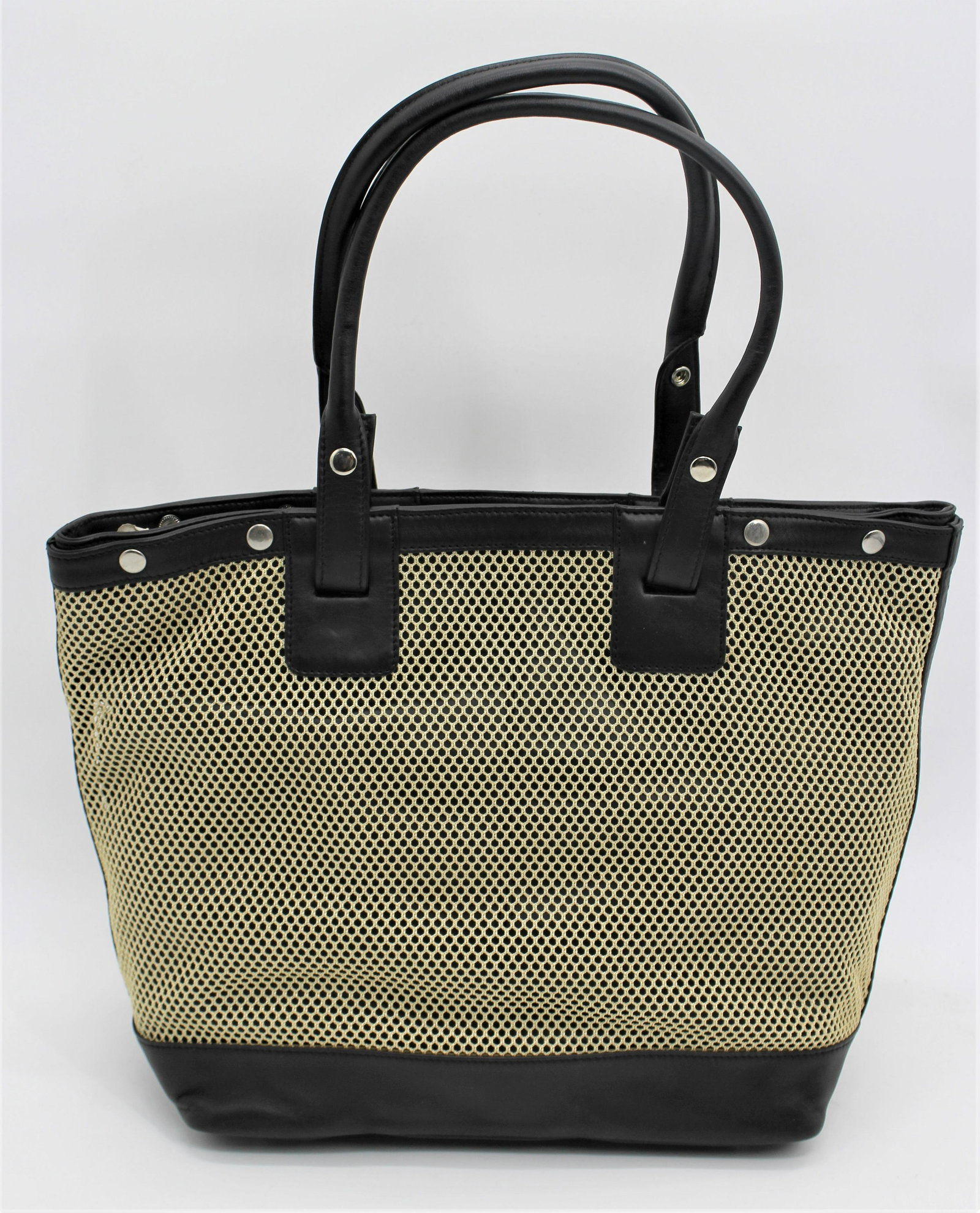 Levenger Bag: Two materials - 100% leather with mesh. Mesh and straps are removable.
