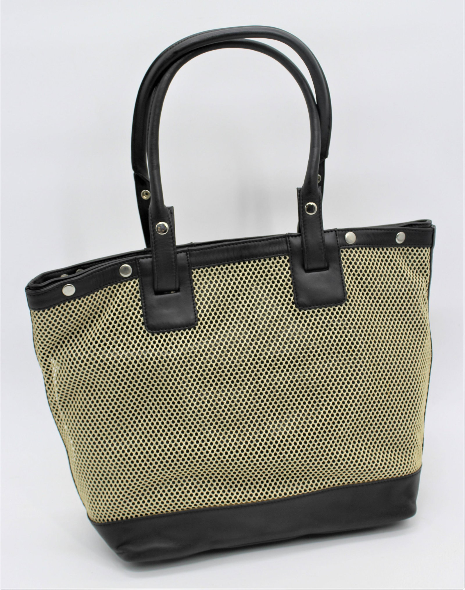 Levenger Bag: Two materials - 100% leather with mesh. Mesh and straps are removable.