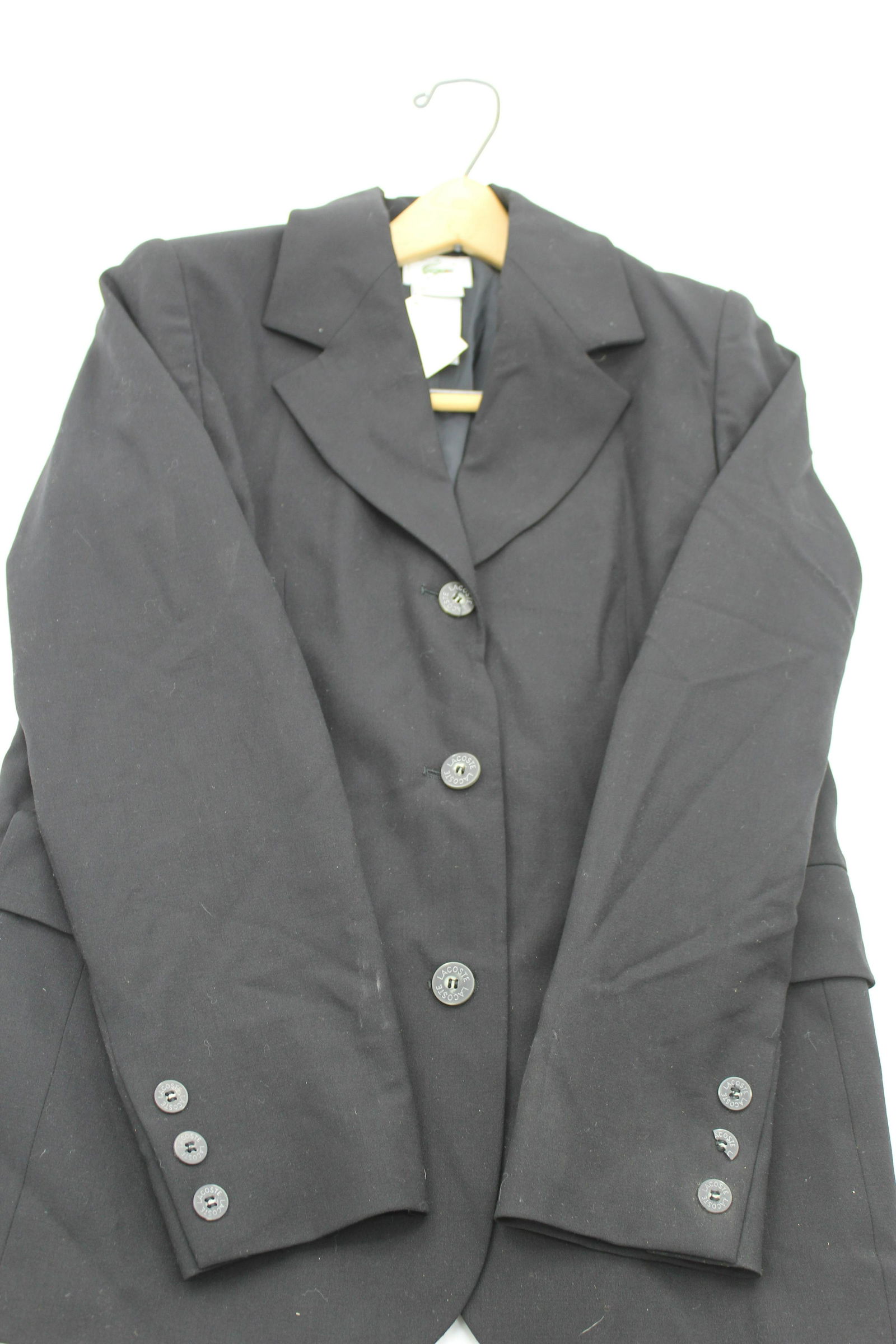 Lacoste Black Blazer: 96% wool. Size 38 three button blazer with pockets. 1/2 button missing on left sleeve.24x17. Original price $395