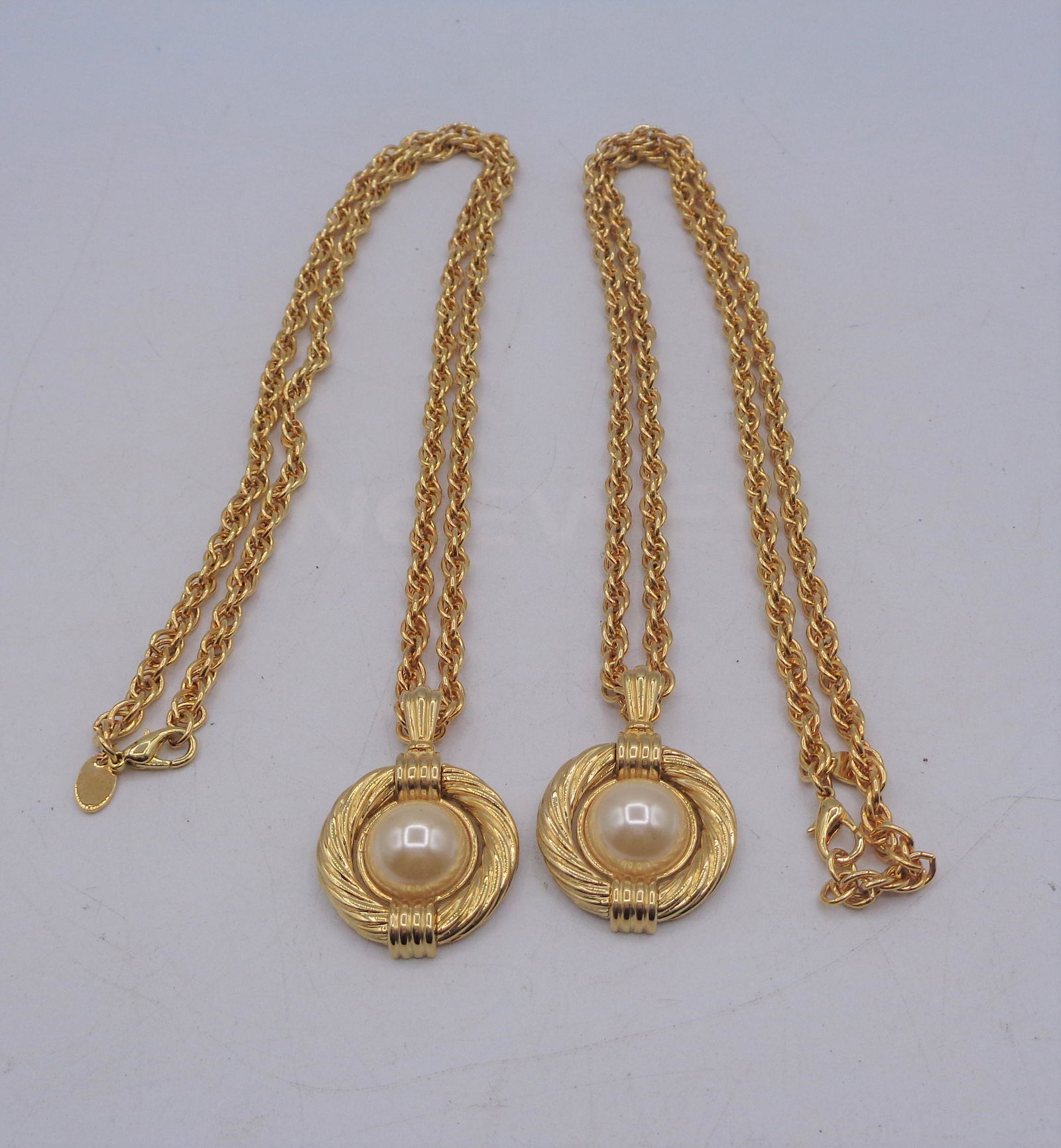 Erwin Pearl Jewelry Lot: Two gold colored necklaces with a faux pearl in the middle. Faux pearl necklaces measure 16" inches long.