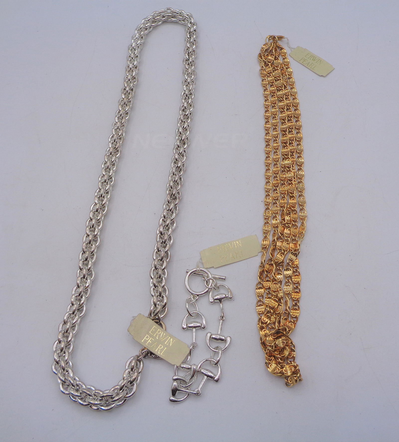 Erwin Pearl Jewelry Lot: Lot of 3 Erwin Pearl pieces of silver and gold toned jewerly. Silver Bracelet measures 4.5" inches long. Silver necklace measures 14" inches long. Layered gold necklace measures 12" inches long.