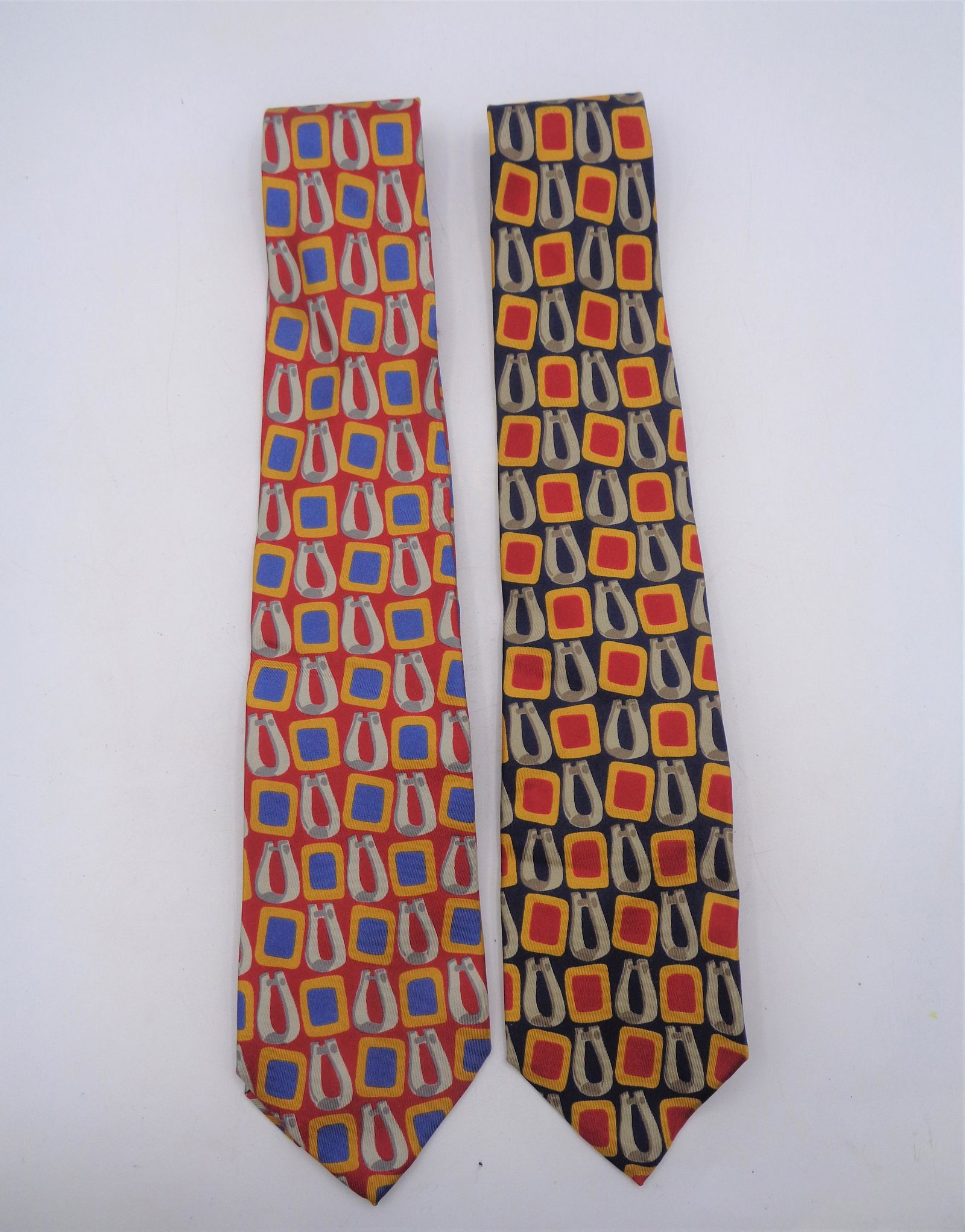 Gucci Tie Lot: Two color variation of the same pattern. First, has a base color of blue and the second, a base color of red. 100% silk and made in Italy!
