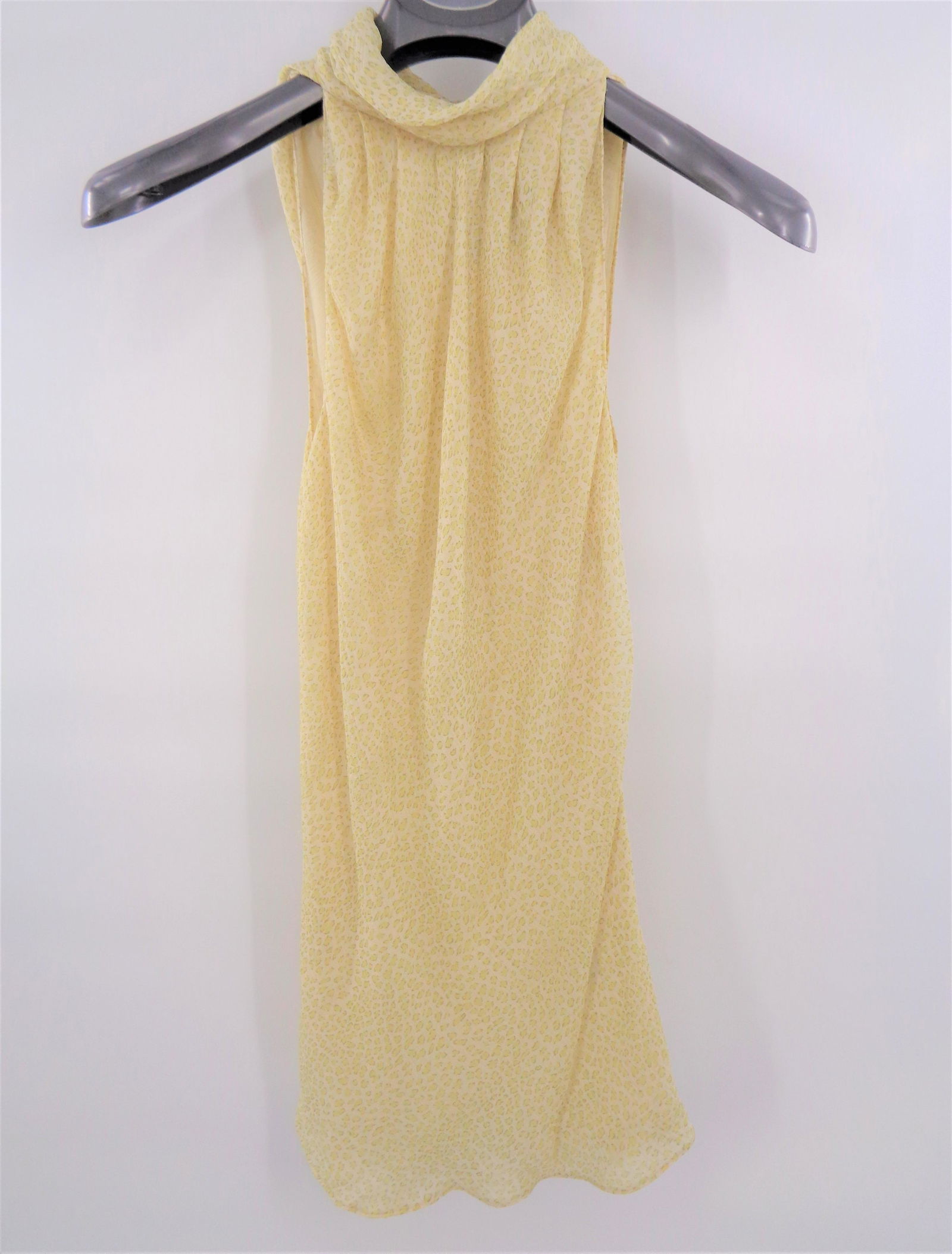 DKNY Sleeveless Blouse: Light airy fabric makes this piece the perfect item for spring and summer! Subtle animal print. Peek-a-boo back with tie. 100% silk. Item is a size 6. Original price $228.