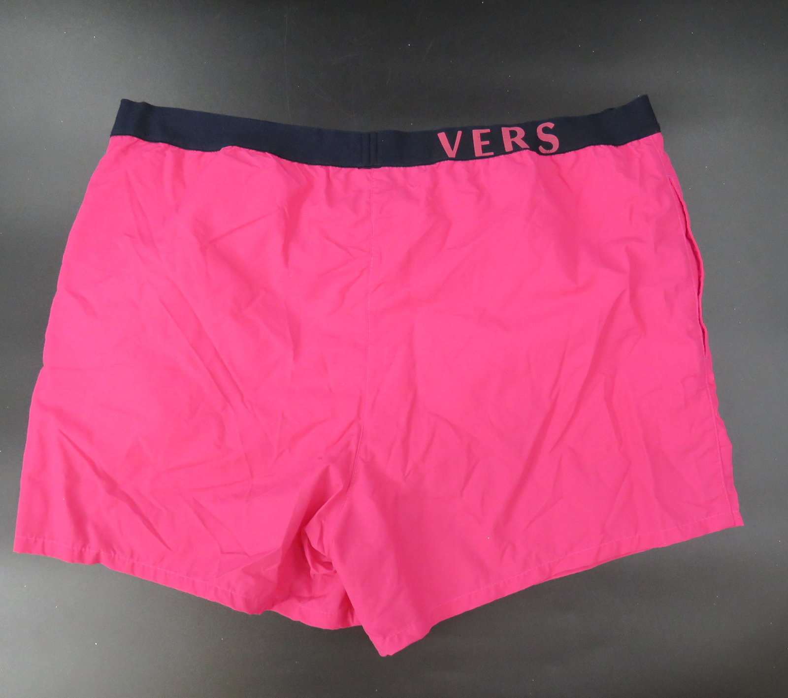 Versace Hot Pink Swim Trunks: Swim in style this summer! Hot pink, Versace swim trunks that are sure to make a statement! Men's size L. swimsuit has pockets and liner!