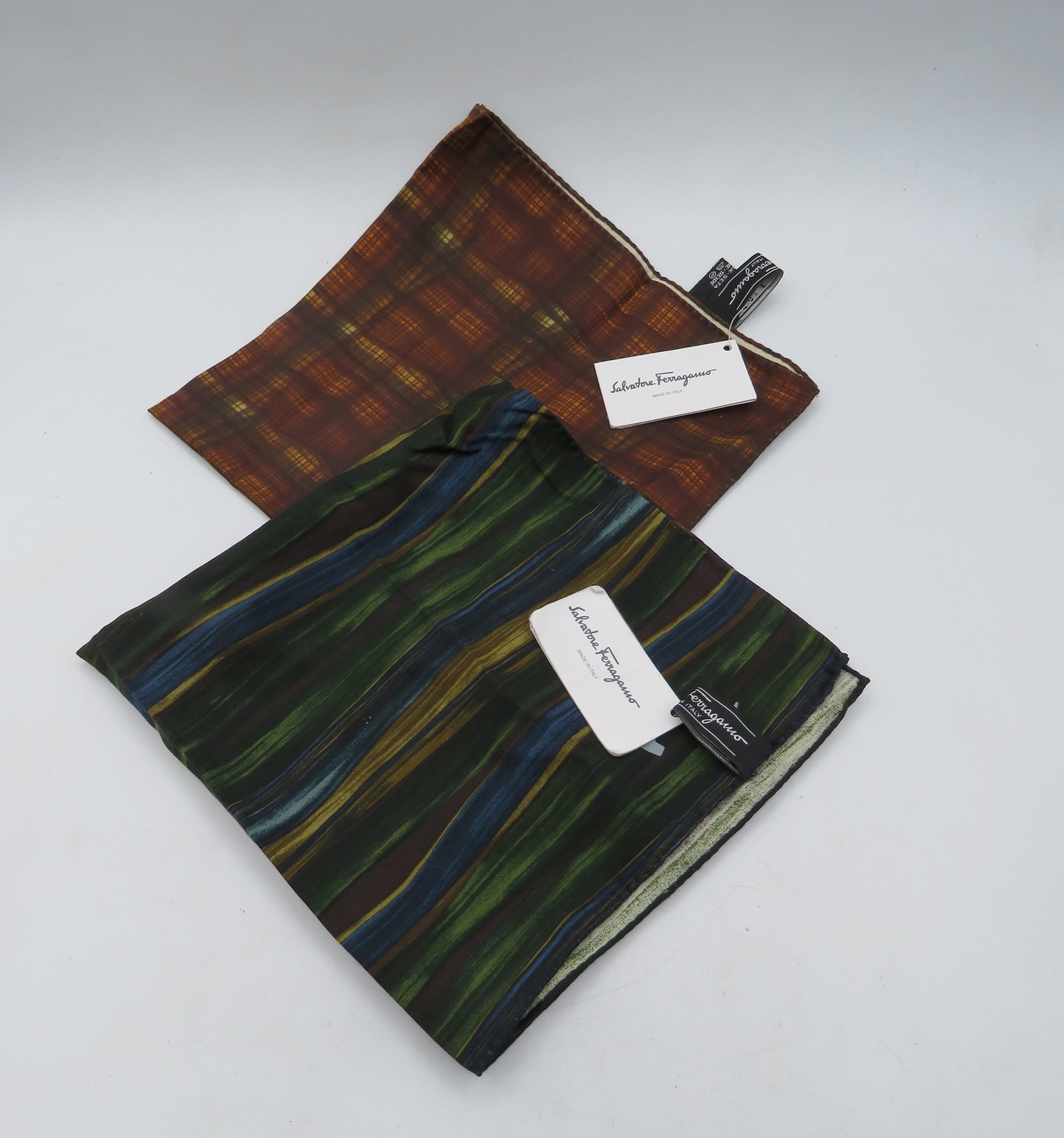 Lot of 2 Ferragamo Silk Handkerchiefs: Brown & yellow plaid & 1 green multi-color with stripes.