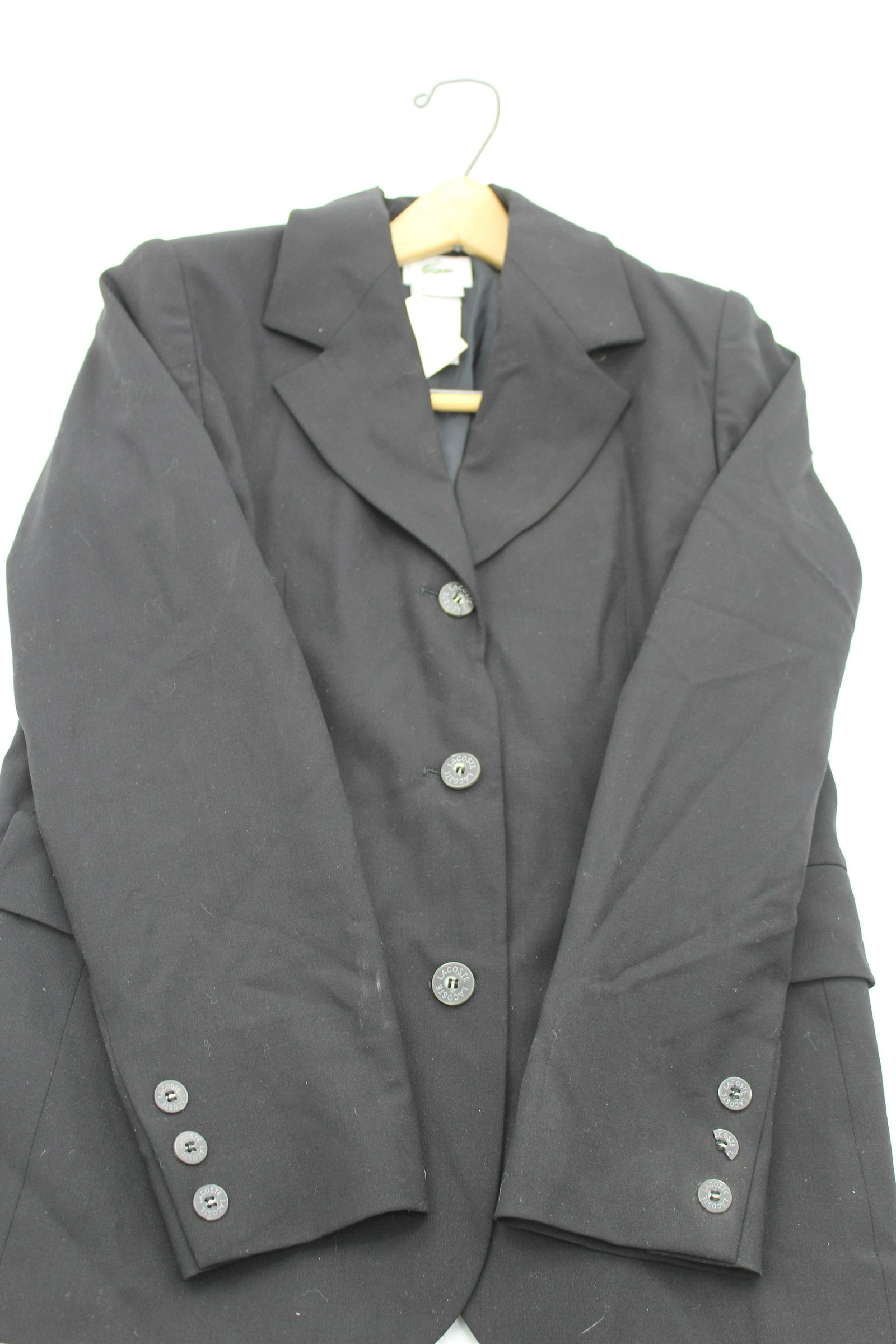 Lacoste Black Blazer: 96% wool. Size 38 three button blazer with pockets. 1/2 button missing on left sleeve.24x17. Original price $395
