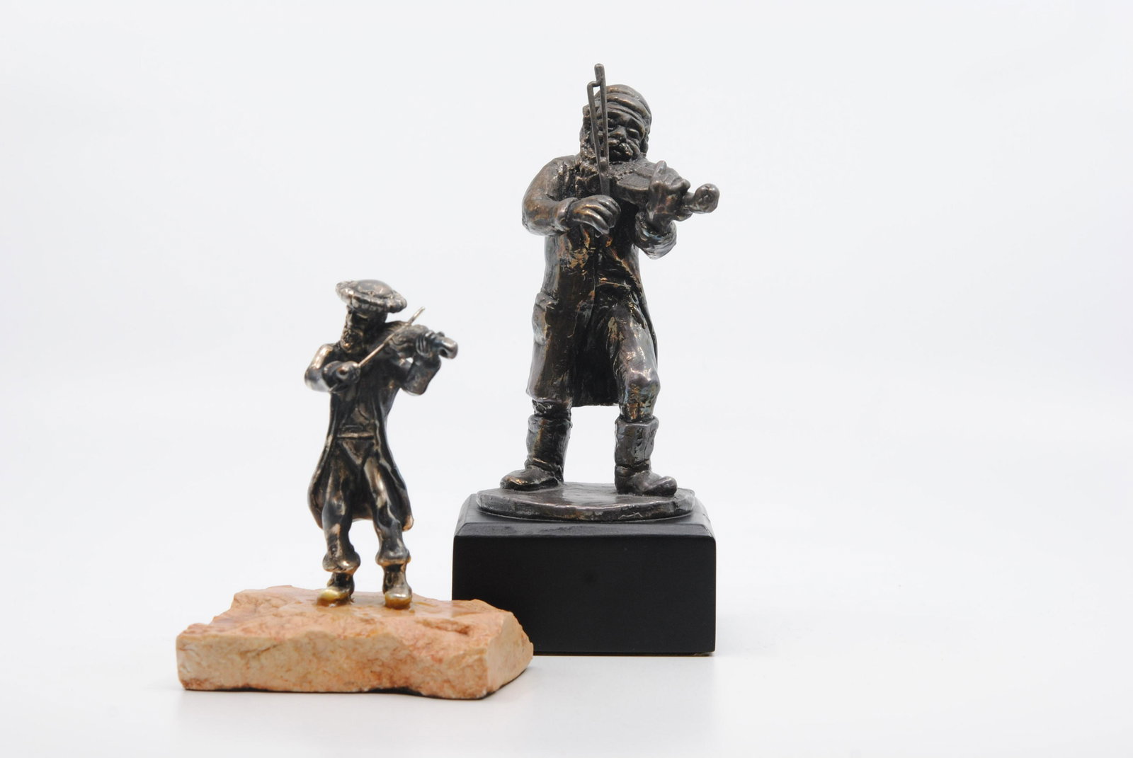 Hadany Silver Arts Yoel Zidon Judaica Fiddler Figurines: Hadany Silver Arts figurines. One figurine is of an older man playing the violin. Inscribed in Hebrew, and has the name Yoel Zidon on the back plate, mounted on a wooden base. The other figurine is of
