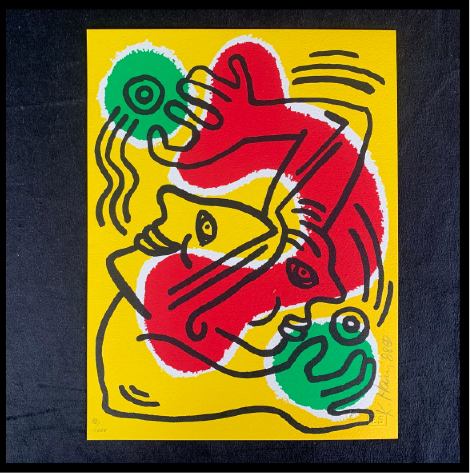 Keith Haring's "International Youth Year" Limited Edition Print: Keith Haring's "International Youth Year" limited edition print, signed lower right and numbered 42/1000 lower left. Done in Haring's signature style, this piece is of two faces, with two hands, appea
