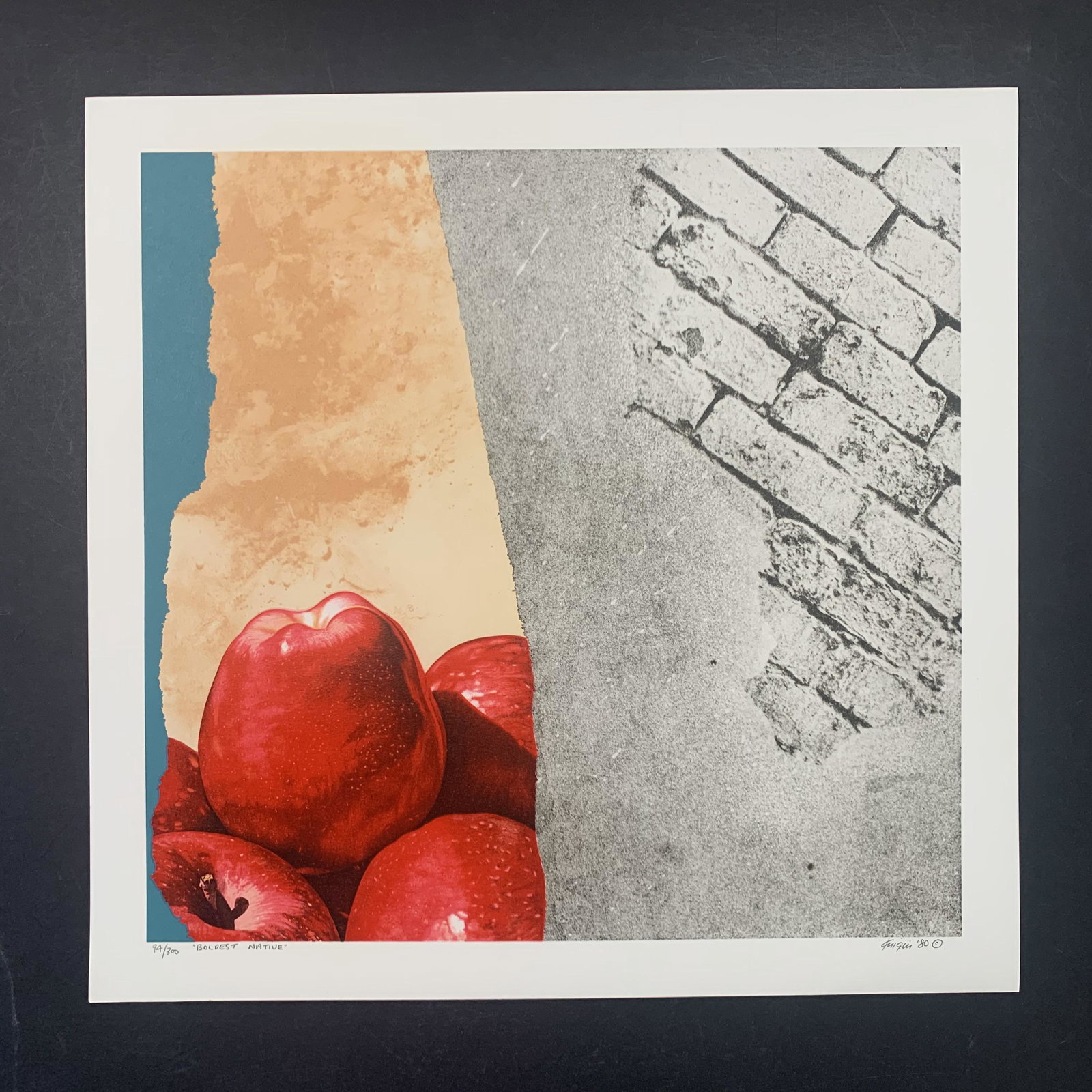 Michael Knigin's "Boldest Native" Limited Edition Print: Michael Knigin's "Boldest Native" limited edition print, signed lower right, and numbered 94/300 lower left. This piece is a clode up of a few red apples, and a grey brick wall. This piece is in excel