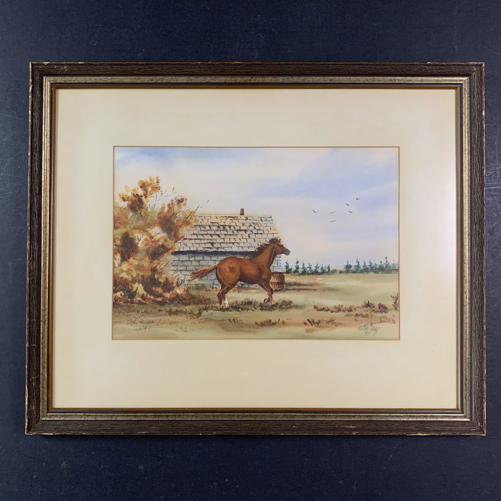 Cecil B. Staigh's "Steed" Original: Cecil B. Staigh's "Steed", circa 1977, original watercolour on paper painting, signed and dated lower right. This piece is of a profile of a brown horse, that is staning in front of a stone building. 