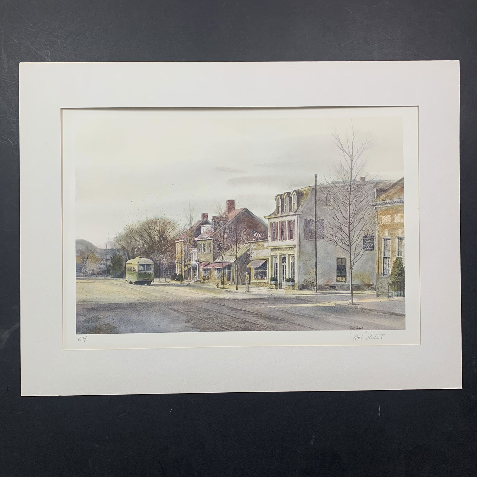 Paul Rickert's "Heading Home" Limited Edition Print: Paul Rickert's "Heading Home" circa 1974, limited edition print on paper, signed lower right, and dated lower left, from the Franklin Mint. This piece is of a quiet street in a small town, with busine