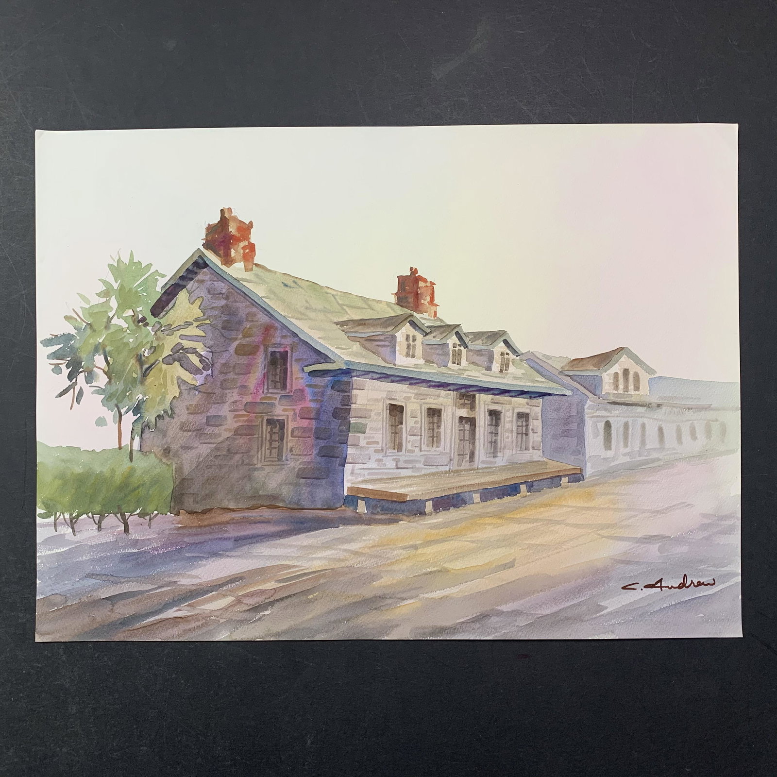 C. Andrew's "Small Town Sunday" Original Print: C. Andrew's "Small Town Sunday" original print. This piece is of a few homes, on a quiet road in a small town, and done in a watercolour style. This piece is in near excellent condition with a minor c