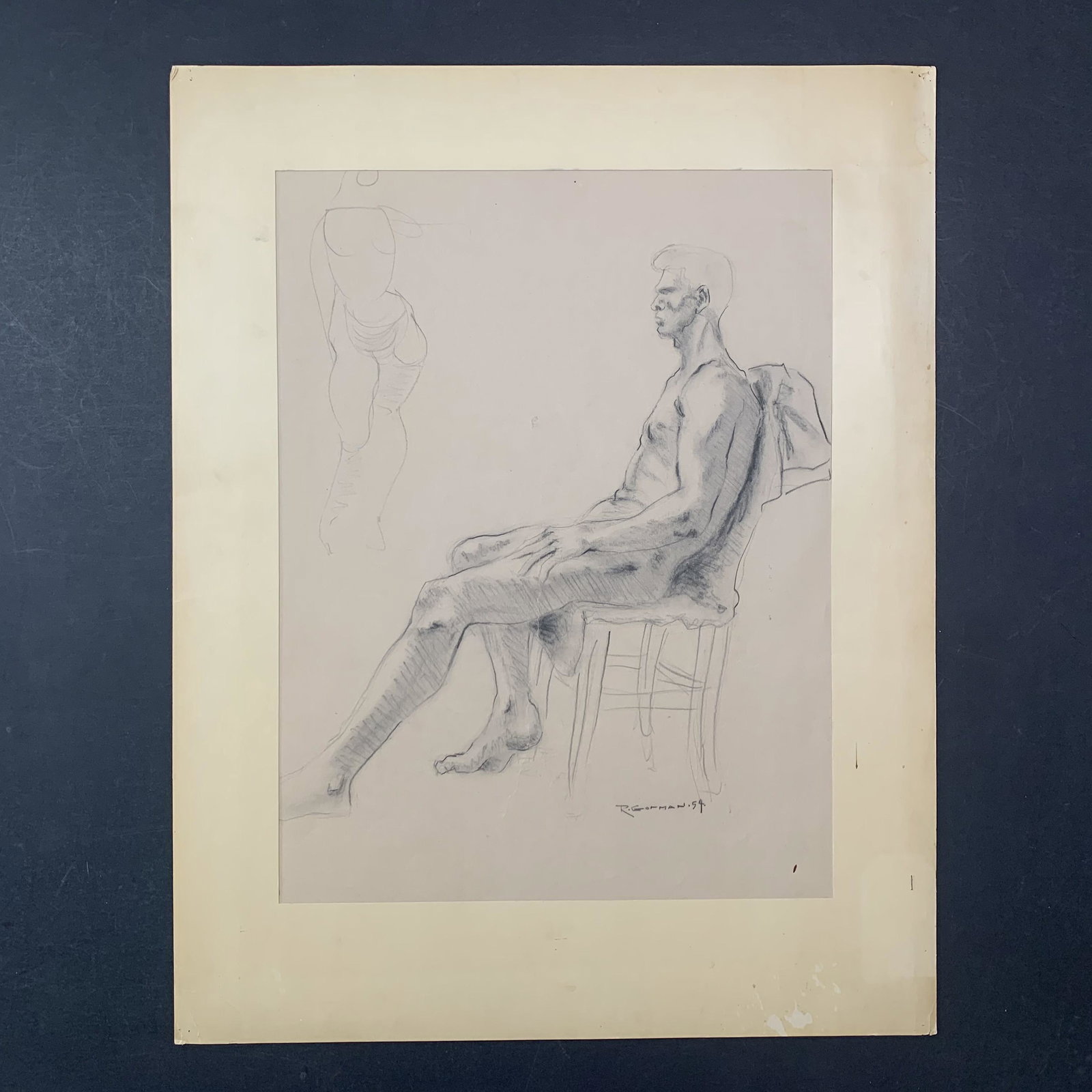 Rudolph Carl Gorman Original Sketch: An original sketch by Rudolph Carl Gorman of a nude man sitting, staring at a half completed other figure. This piece is in excellent condition and has been matted. Image: 22 1/2" x 16 1/2". Matting: 