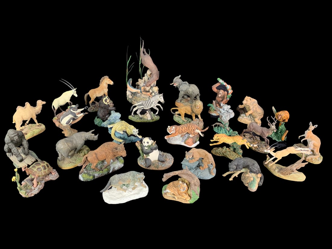 Franklin Mint Wildlife Figurines: A group of 27, wildlife figurines produced by the Franklin Mint. Includes "Gorilla Gorilla", "Rhinoceros Unicornis", "Panthera Leo Persica", "Felis Lynx Pardina", "Panthera Onca", "Geochelone Elephant