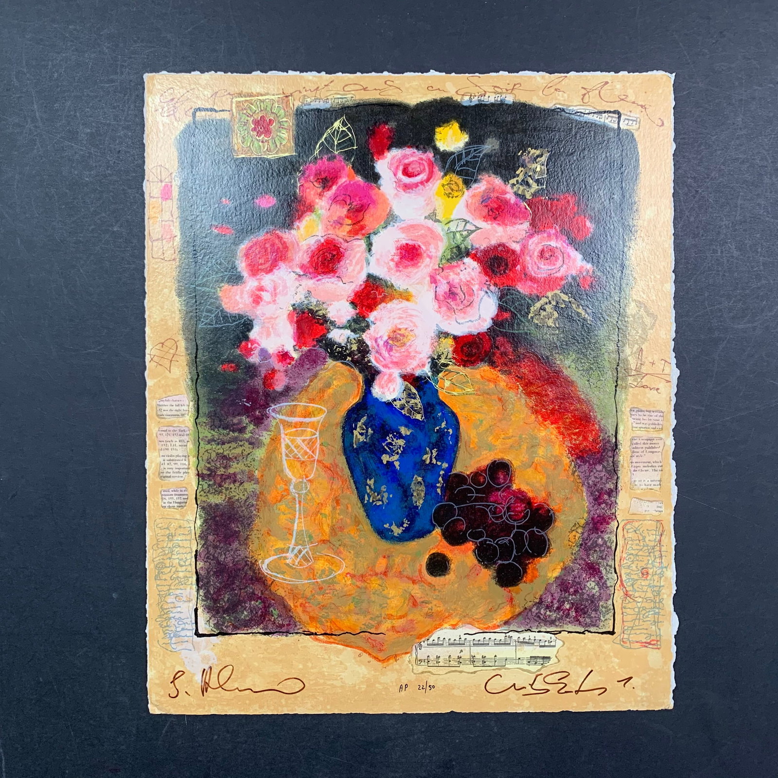 Alexander Wissotzky's "Evening Bouquet" Limited Edition Print: Alexander Wissotzky's "Evening Bouquet" Limited Edition Print. A crystal glass, some red grapes and bouquet of pink roses in a blue vase atop a table. This piece is signed along the bottom edge and nu