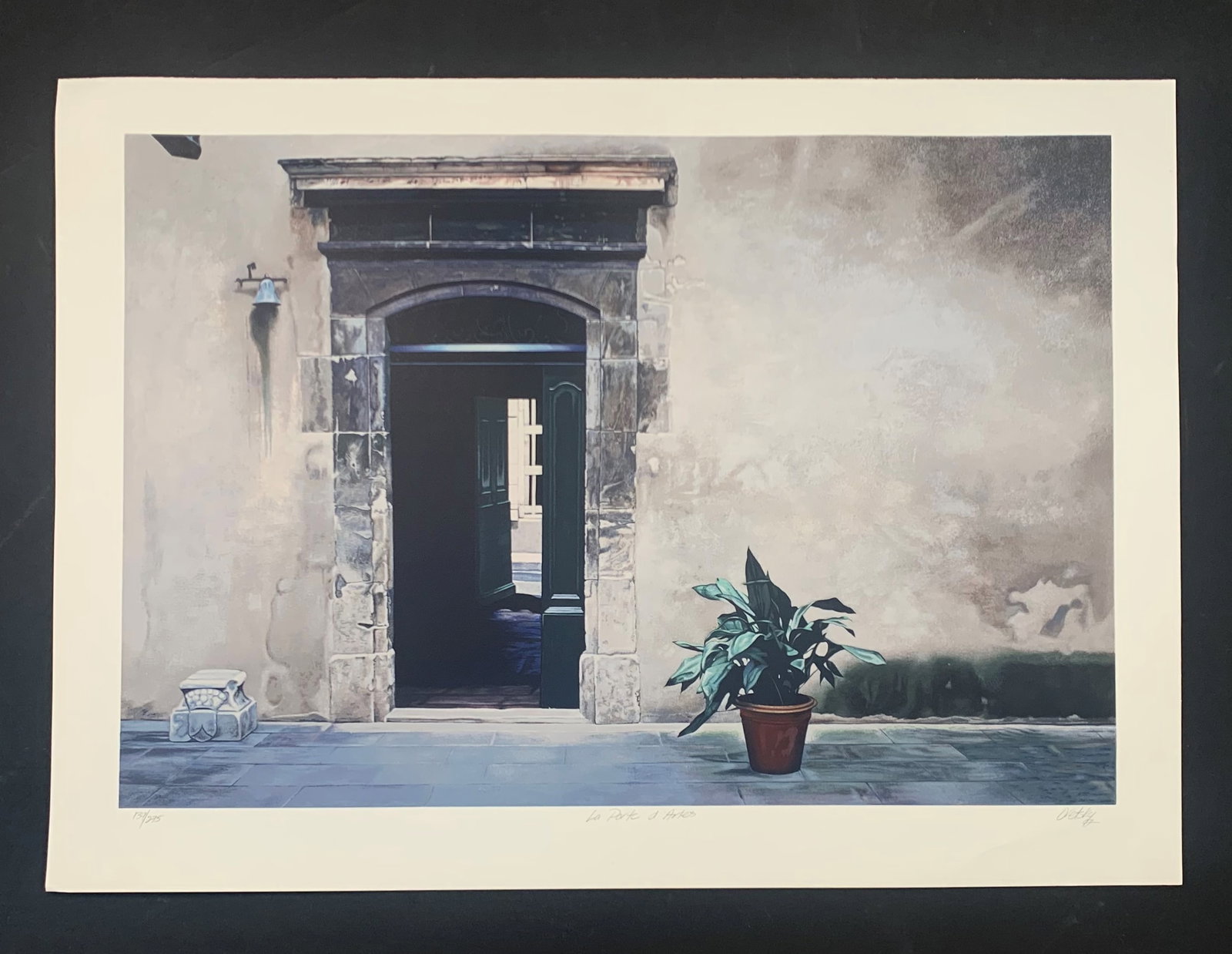 Barry Oretsky's "La Porte d'Arles" Limited Edition Print: Barry Oretsky's "La Porte d'Arles" limited edition print, signed lower right, and numbered 139/275 lower left. This piece is a wall with a doorway, and a potted plant in the foreground. This piece is 