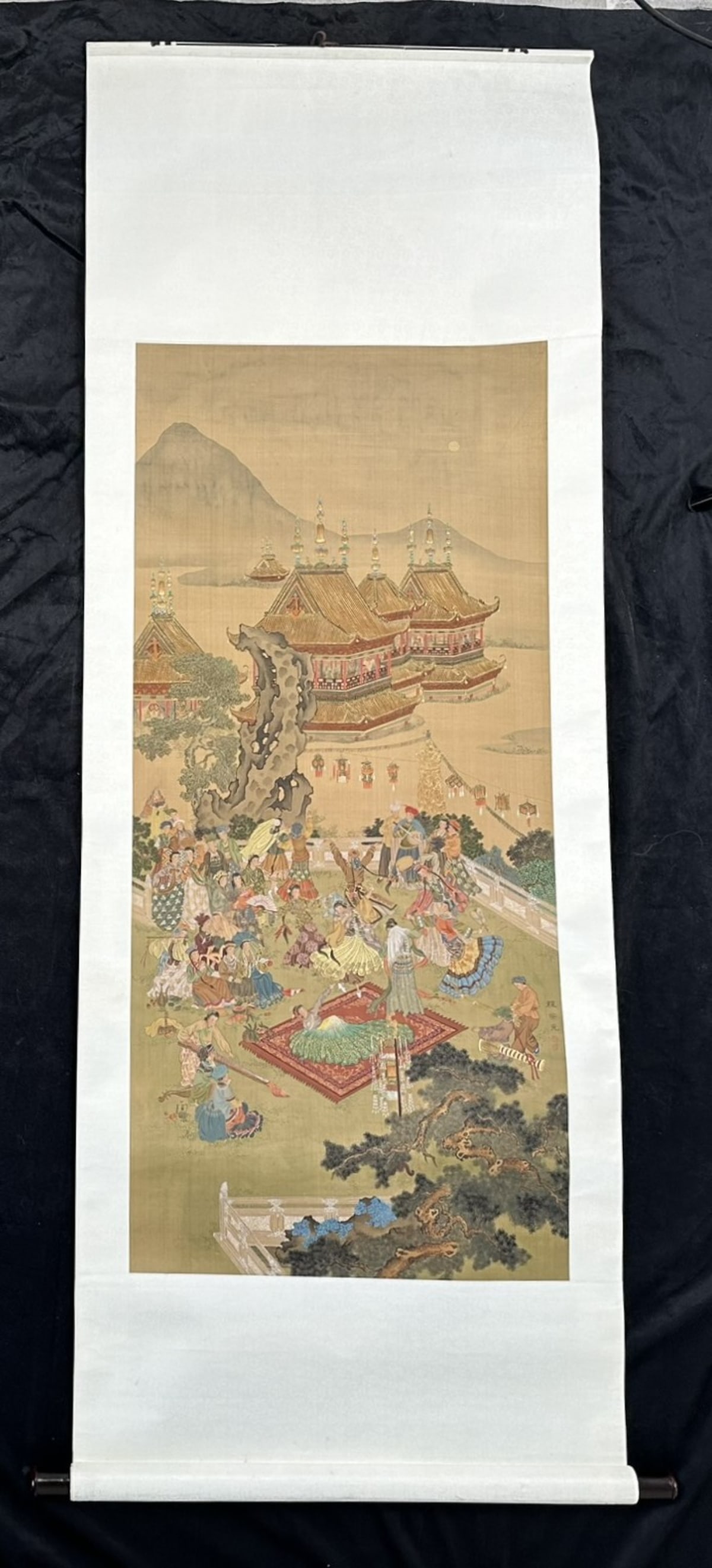 Chinese Scroll Painting: Chinese scroll painting of people dancing in a garden, signed upper left, in excellent condition. Image: 71" x 26"