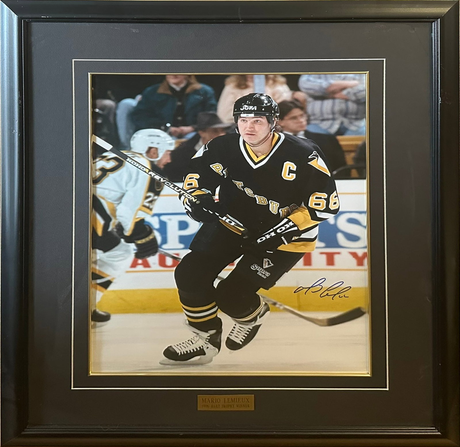 Framed Autographed Mario Lemieux Pittsburgh Penguins Photo - NHL Hall of Famer, 1996 Hart Trophy: Offered here is a professionally framed and autographed photo of legendary NHL Hall of Famer Mario Lemieux, shown mid-action during his iconic career with the Pittsburgh Penguins, wearing the captain�