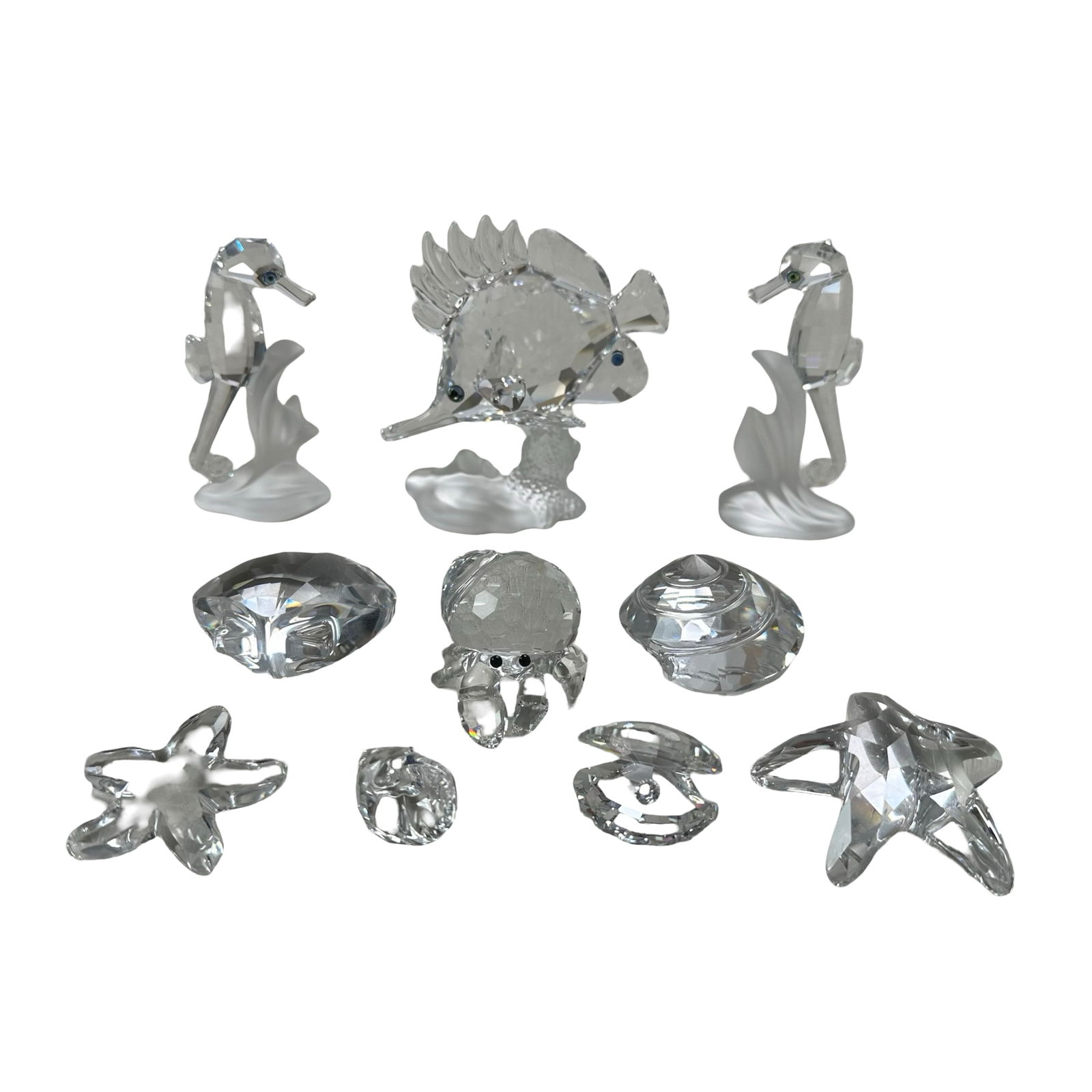 Stunning Swarovski Crystal Marine Figurine Collection - Seahorses, Tropical Fish, Starfish & Shells: This breathtaking Swarovski Crystal Marine Collection showcases a curated ensemble of meticulously crafted figurines inspired by the wonders of the sea. Each piece is masterfully rendered in precision