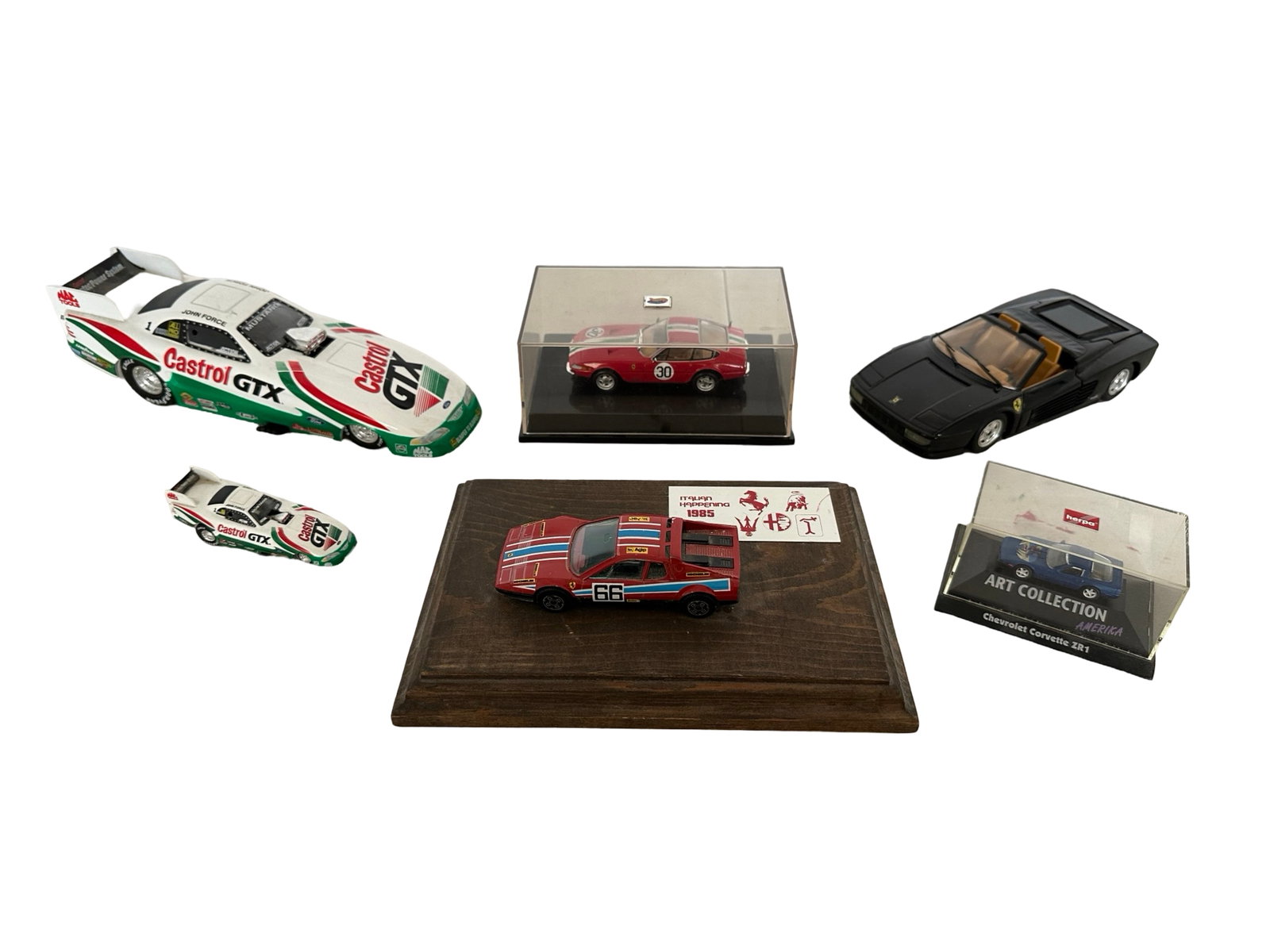 Ferrari and Racing Model Die Cast Cars: A group of die cast model cars, containing Ferraris and racing cars. Includes a Ferrari Testarossa 1:24, John Force Racing 1997 Mustang Funny Car 1:24, Ferrari 512 BB 1:43 on wood base, Ferrari 365 GT