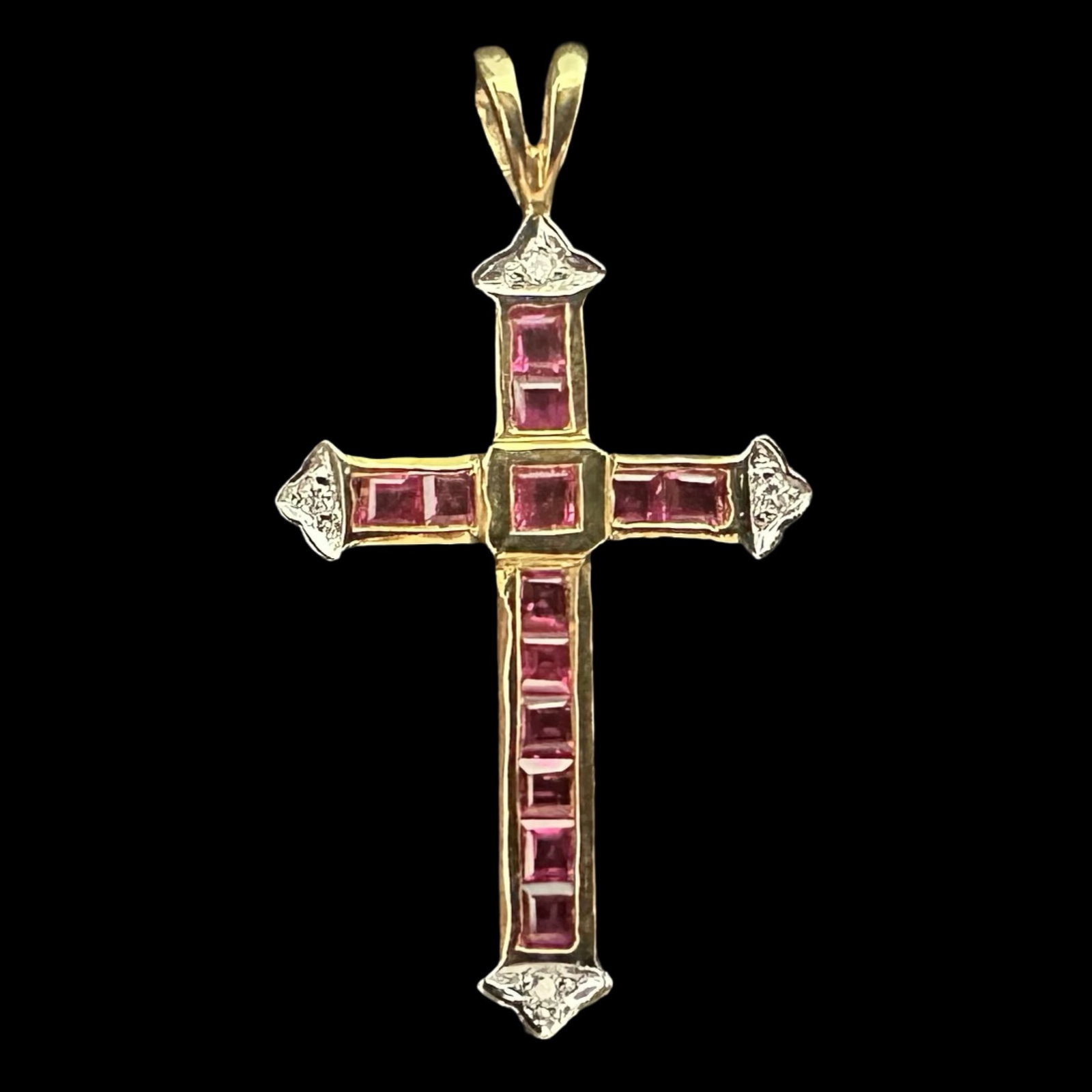 18K Yellow Gold Calibré-Cut Ruby & Diamond Cross Pendant - Hallmarked “750 / 18K", Maker’s: A refined, hand-crafted cross pendant in rich 18K yellow gold, channel-set with a matched suite of vivid pinkish-red rubies and finished with white-metal diamond caps at the four cardinal points. The 