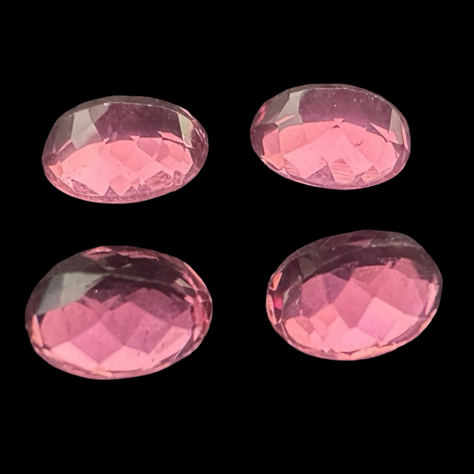 Natural Pink Tourmaline Oval Quartet - 5.60 ctw (four stones), Calibrated 8.13 × 6.09 × 4.39 mm,: A bright, well-matched suite of four natural pink tourmalines totaling 5.60 carats. Each gem is a calibrated oval mixed cut (approx. Portuguese-style crown) measuring 8.13 × 6.09 × 4.39 mm (approx 1
