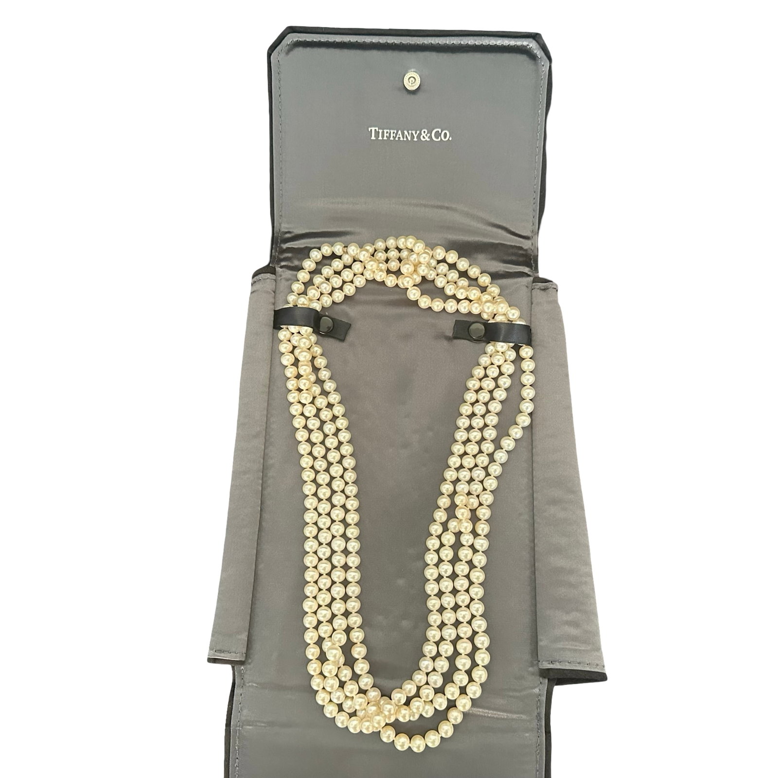 Tiffany & Co. Gray Suede Travel Case with Single Strand Genuine Cultured Pearl Necklace: Presented is a refined Tiffany & Co. gray suede travel case with satin interior, housing a single long strand of genuine cultured pearls. The necklace consists of uniformly round to near-round pearls,