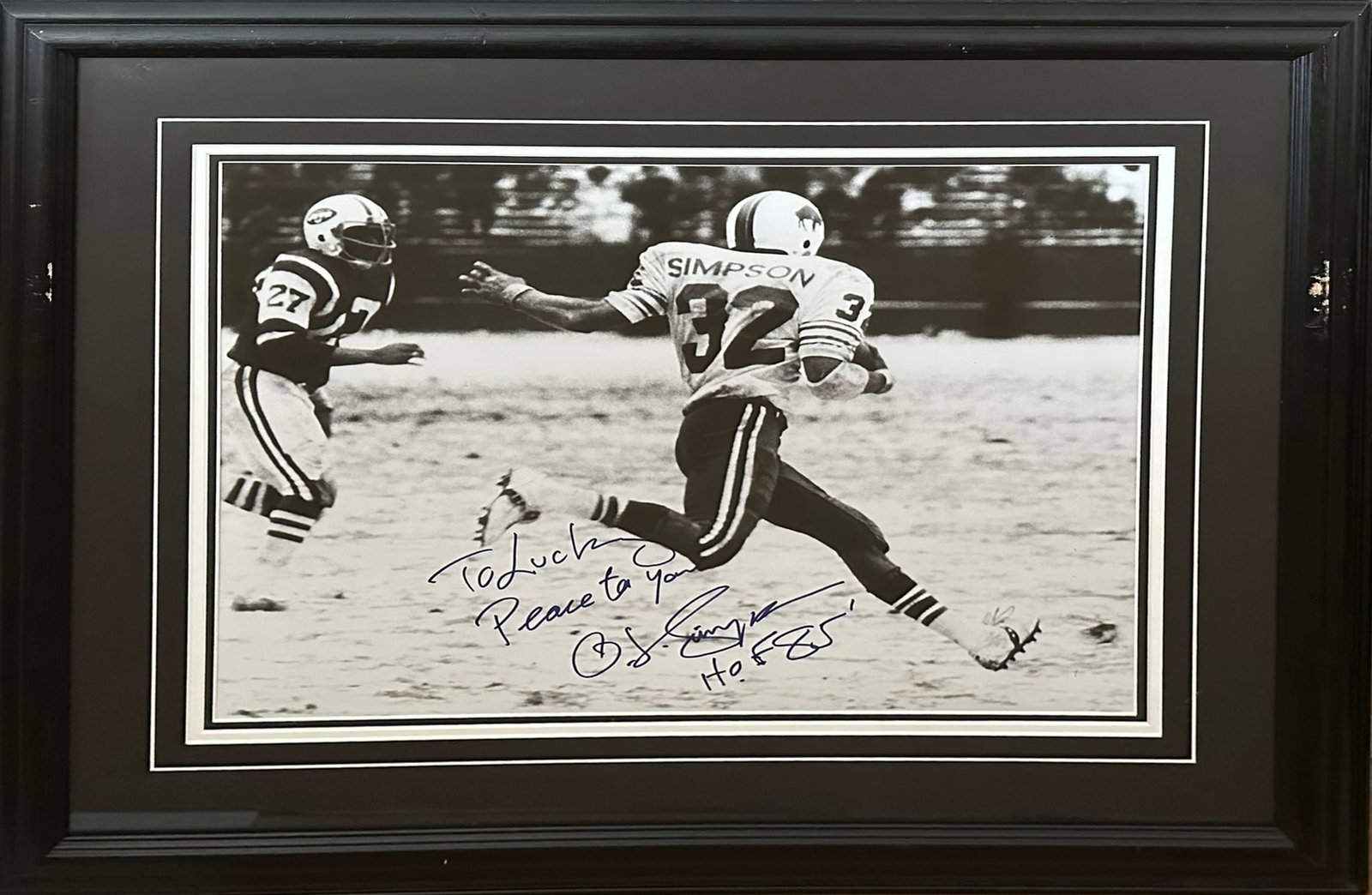 O.J. Simpson Buffalo Bills NFL Signed Photo: An autographed O.J. Simpson Buffalo Bills NFL signed photo. A great action shot of O.J. Simpson running with the ball during a game. Inscribed 'To Lucky Peace to you HOF 85'. Professionally triple mat