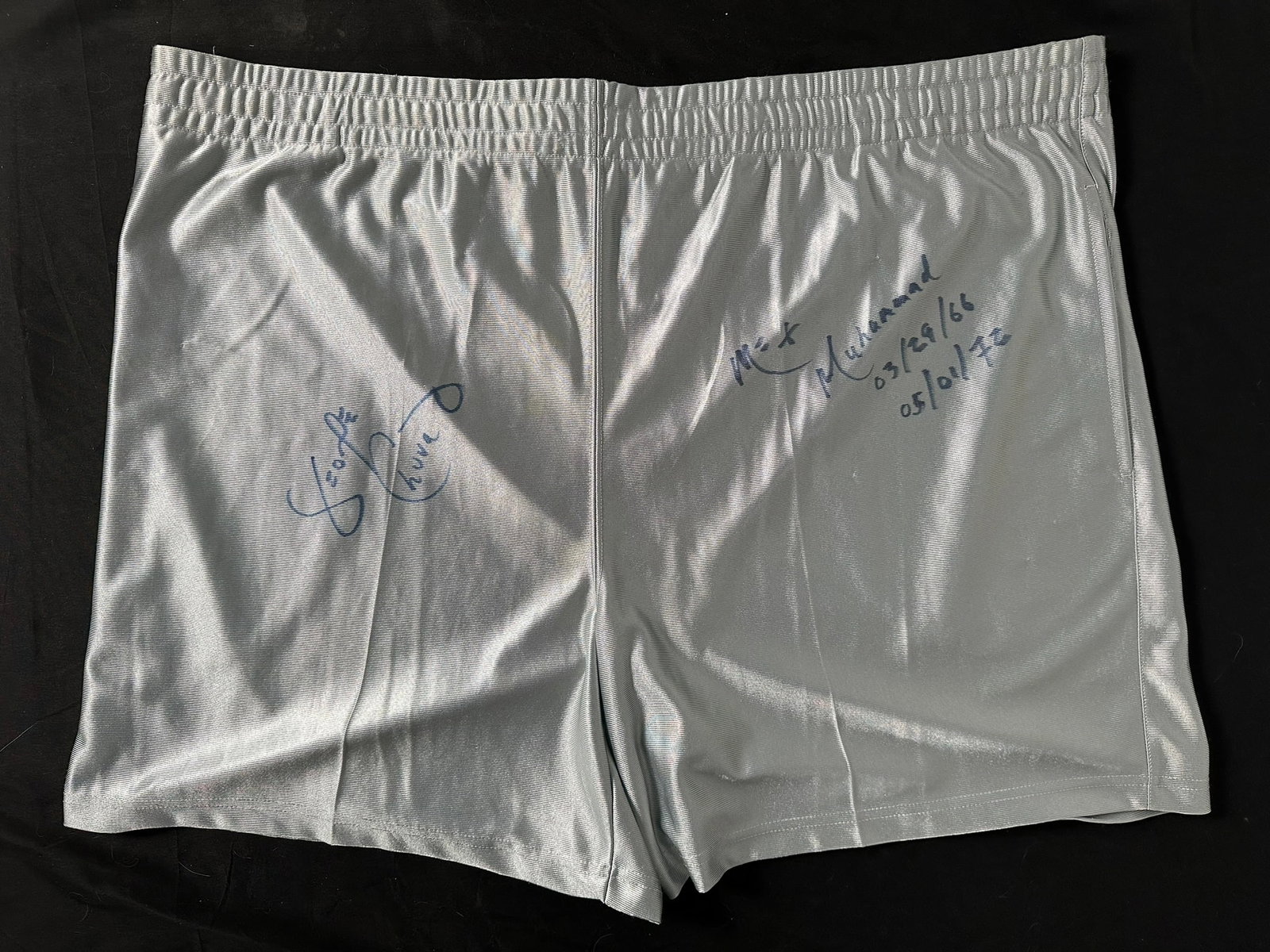 George Chuvalo Signed Shorts: A pair of Sportek 2XL grey shorts, autographed by George Chuvalo, also written by Chuvalo "Me + Muhammad 03/29/66 05/01/72" referring to the dates the fought Muhammad Ali. A great piece of boxing memo