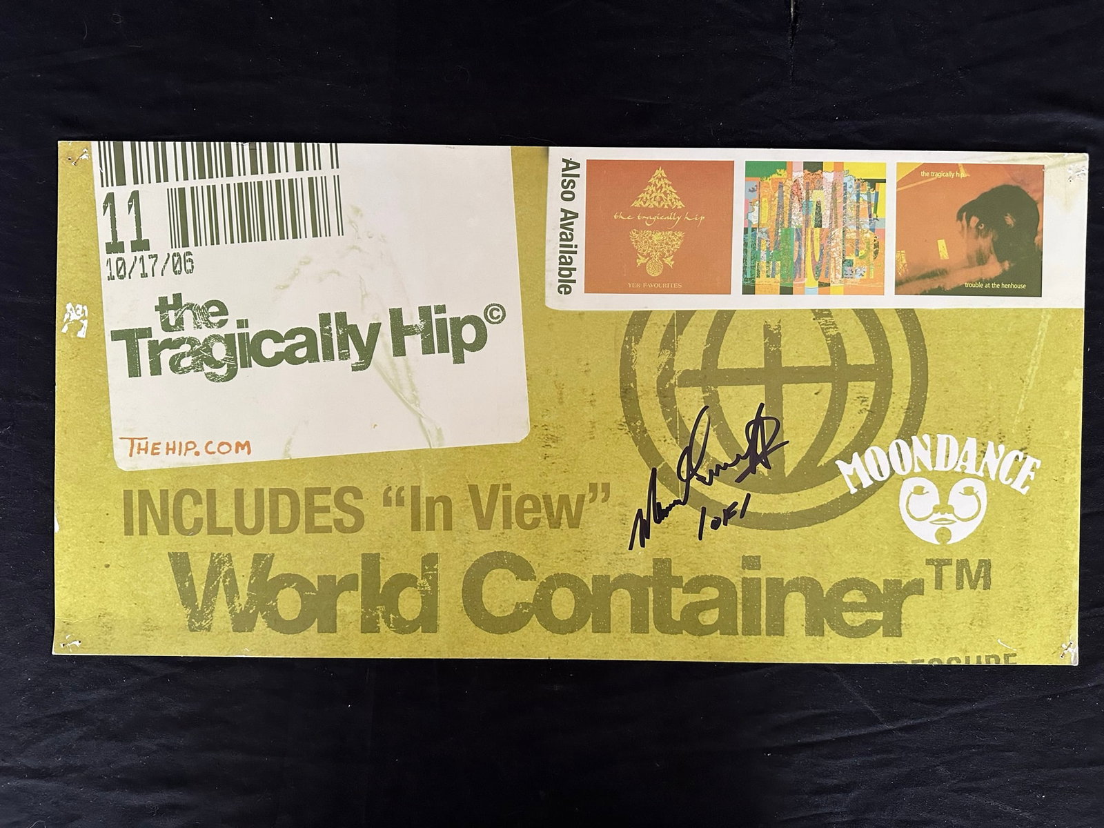 The Tragically Hip "World Container" Publicity Poster: The Tragically Hip "World Container" out of print Moondance cardboard publicity poster, signed 1 of 1. This piece shows signs of pinholes in corners, and some surface damage at left edge. Image: 12" x
