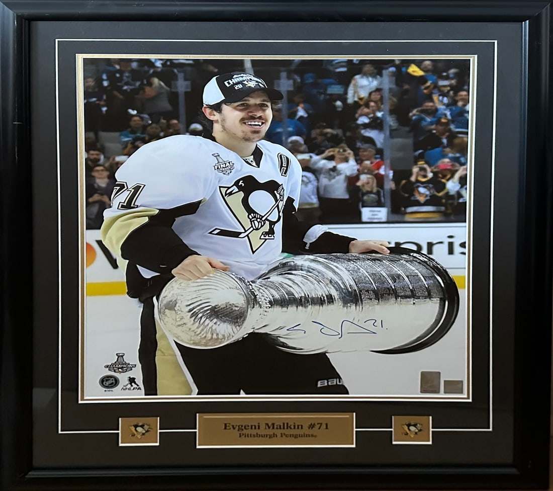 Pittsburgh Penguins Evgeni Malkin Signed Picture: A signed picture of Pittsburgh Penguins' #71 Evgeni Malkin holding the Stanley Cup. This piece has been professionally double matted and custom framed under glass. Included with Frameworth COA. Sports