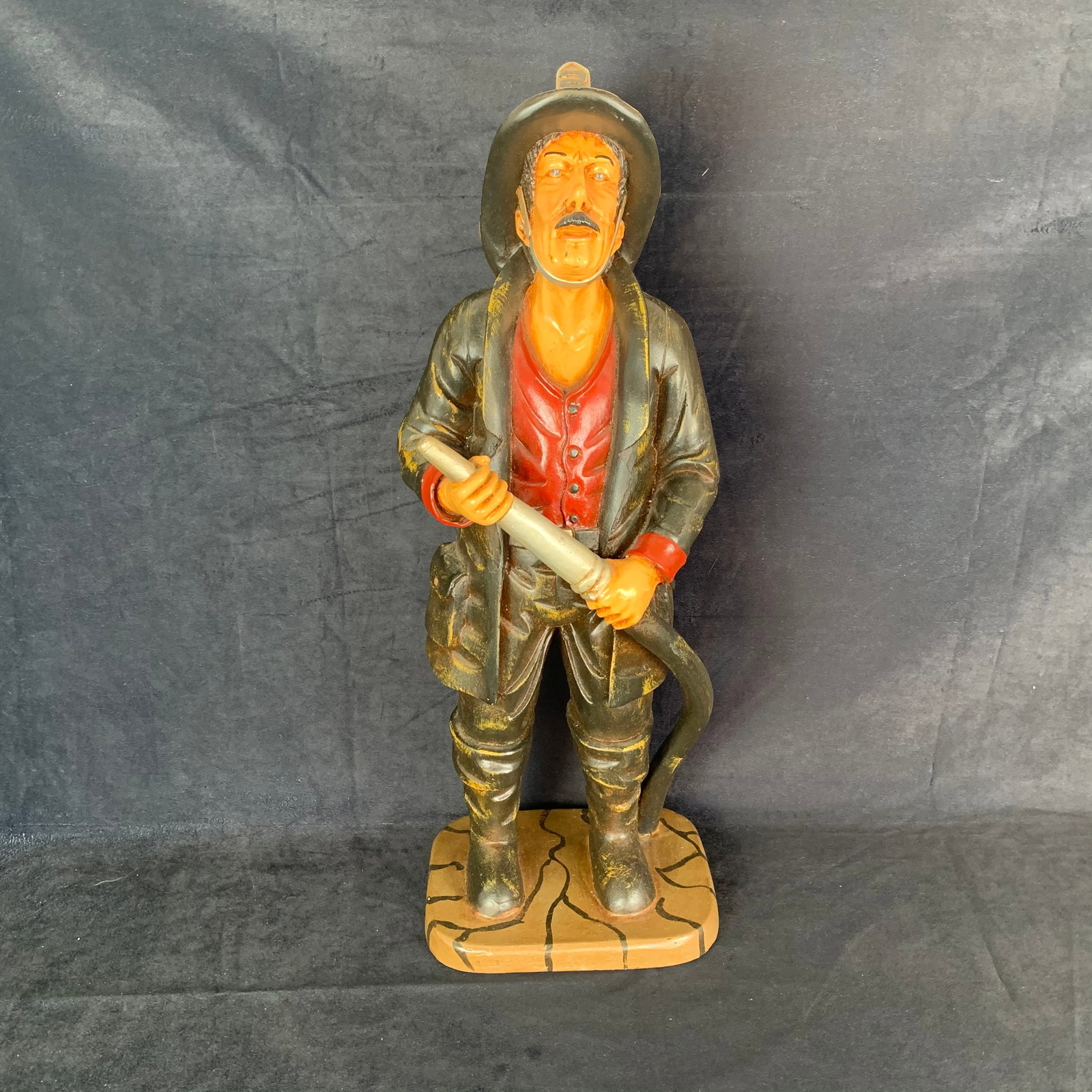 Firefighter Vintage Statue: A vintage firefighter statue. A fantastic piece with great detail, and appears to have no signs of wear or damage. 9" x 7" x 25" tall