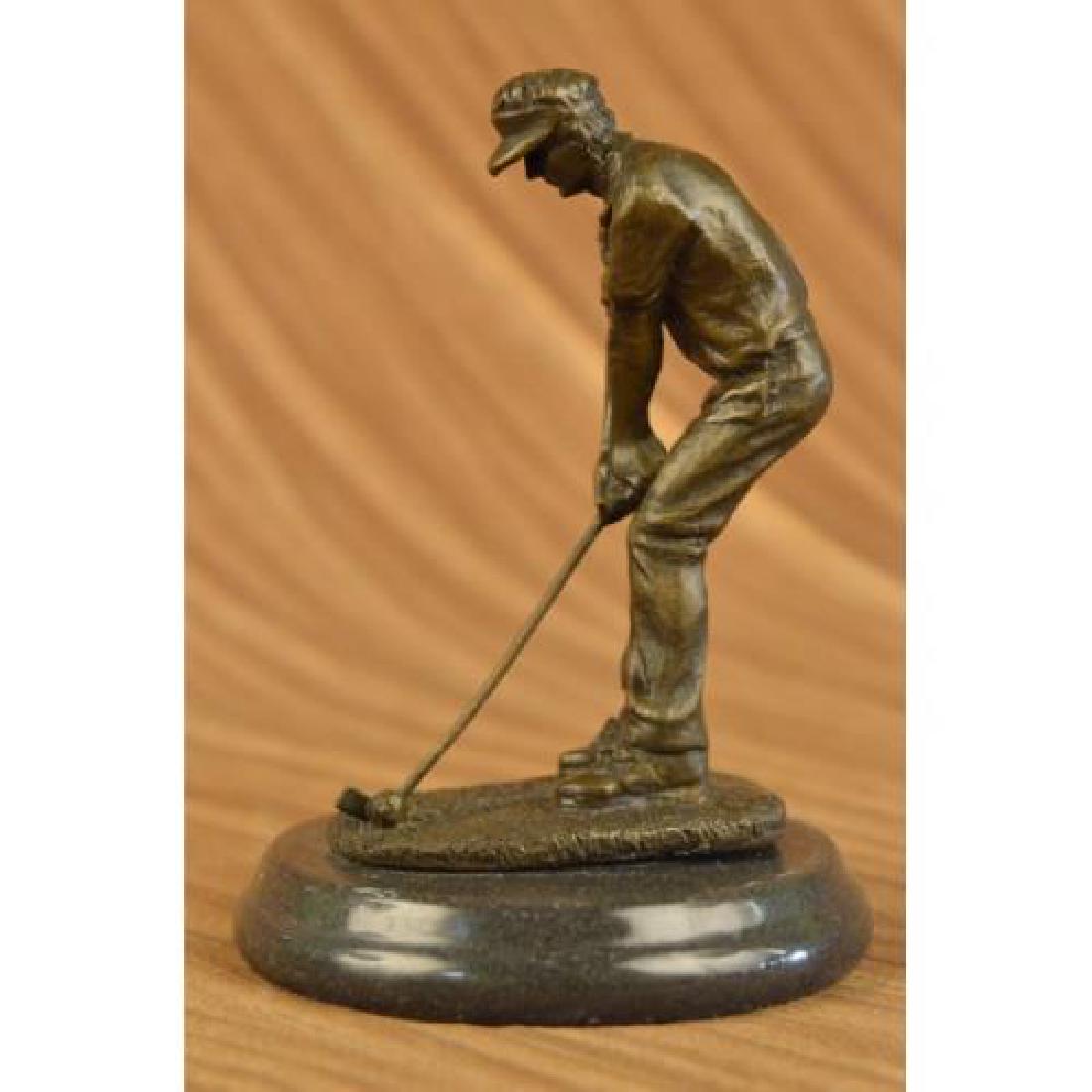 Golfer Bronze Sculpture on Marble Base Statue: Its the perfect swing, he watches his golf ball fly high over the rough and into the green. It is the epitome of the perfect swing. He holds his pose as he watches his ball make its way to the hole. H
