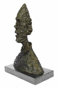 Abstract Man Bust Art Deco Bronze Sculpture: This is a abstract bust of a man. His face is very thin and long, he looks like he has been burned or something. He is wearing like a suit even though you cant see his body. He is the most strange yet