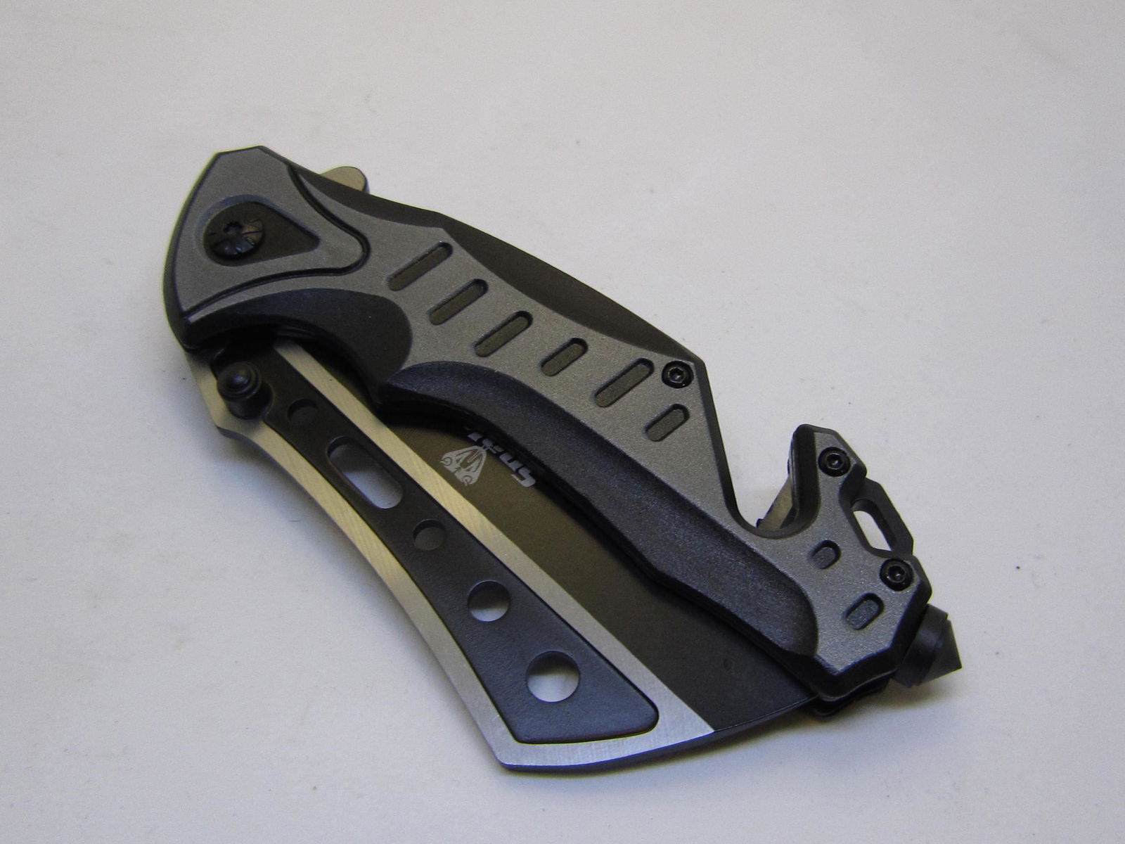 Gray Snake Eye Tactical Spring Assist Knife: Snake Eye Tactical Spring Assist Knife, Two Tone Stainless Steel Razor Style Black blade 3.5 inches. Two Tone Color Handle. Include Pocket Clip, Seat Belt Cutter and Window Breaker Attached. Closed 4.