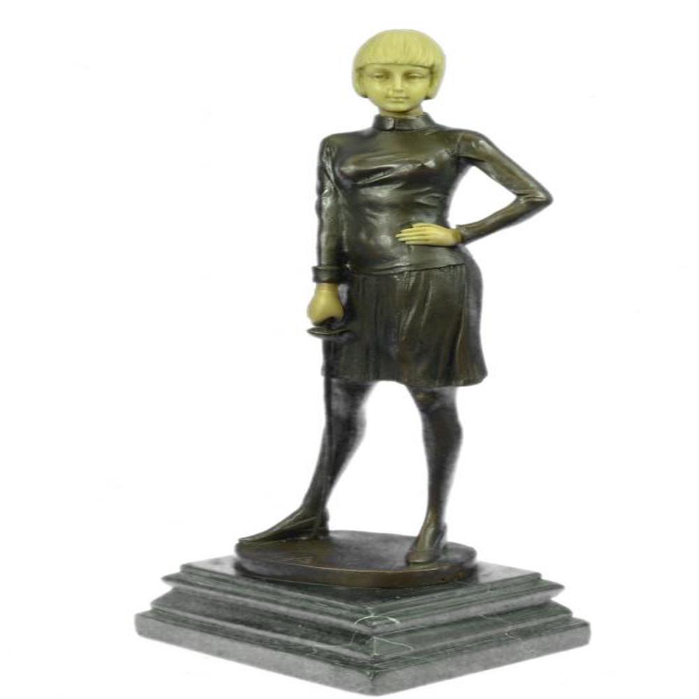 Fencer with Faux Bone holding Foil Bronze Sculpture: An Art Deco hot cast Bronze and faux bone figure of a female fencer, holding a foil in her right hand, on a canted rectangular base. Raised on a marble stepped plinth. Bronze Dimensions with Marble Ba